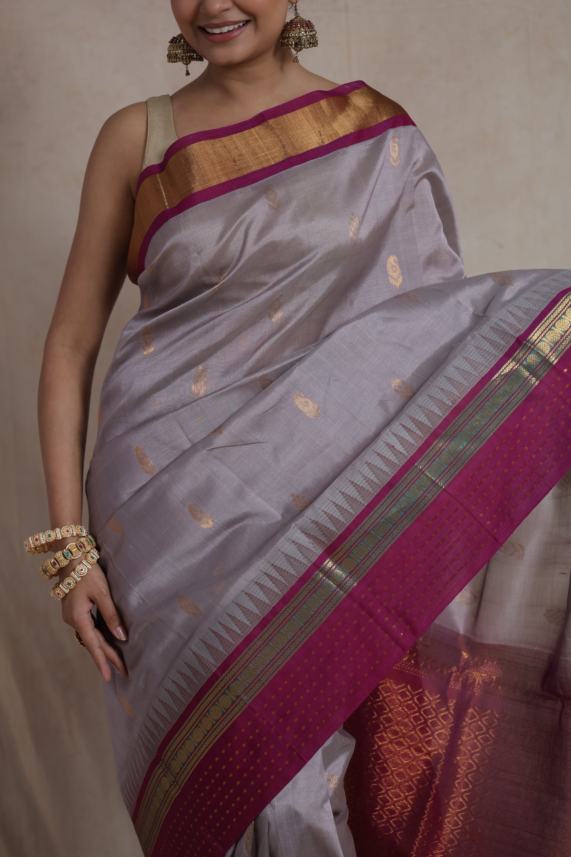 Close-up of silver grey Kanchipuram Sico saree with woven magenta border