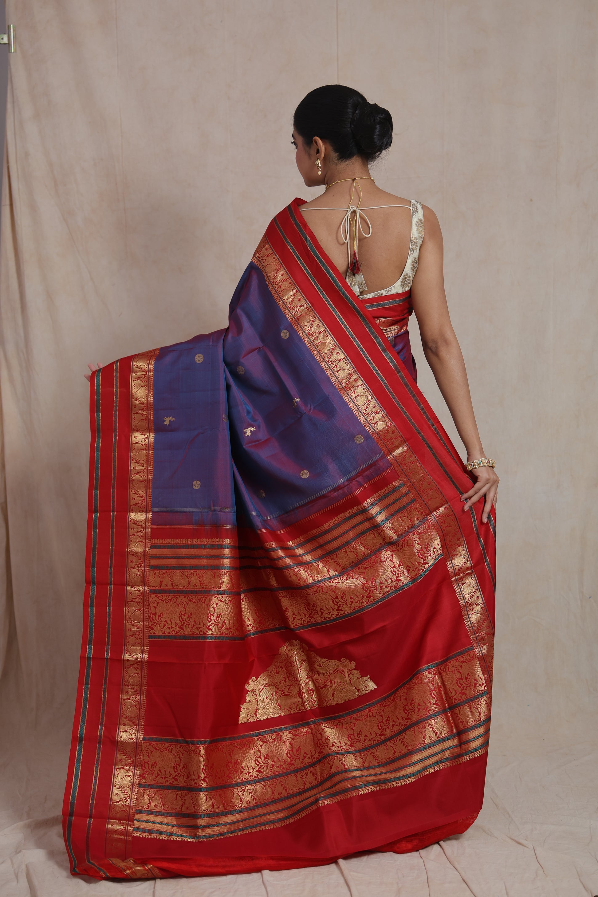Back view of royal violet silk saree with rich red woven pallu