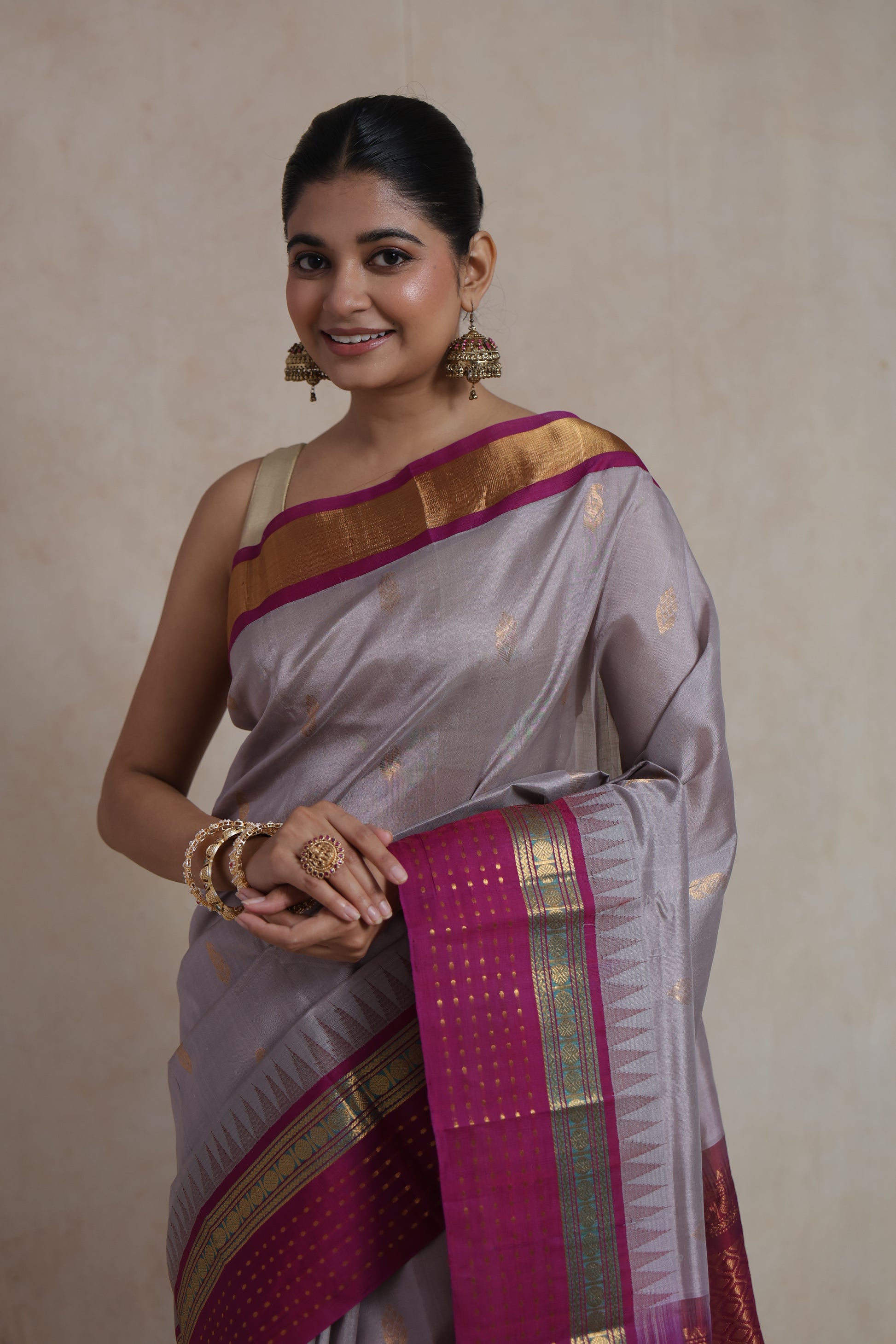 Detailed view of silver grey Sico saree featuring woven buttas and magenta zari border