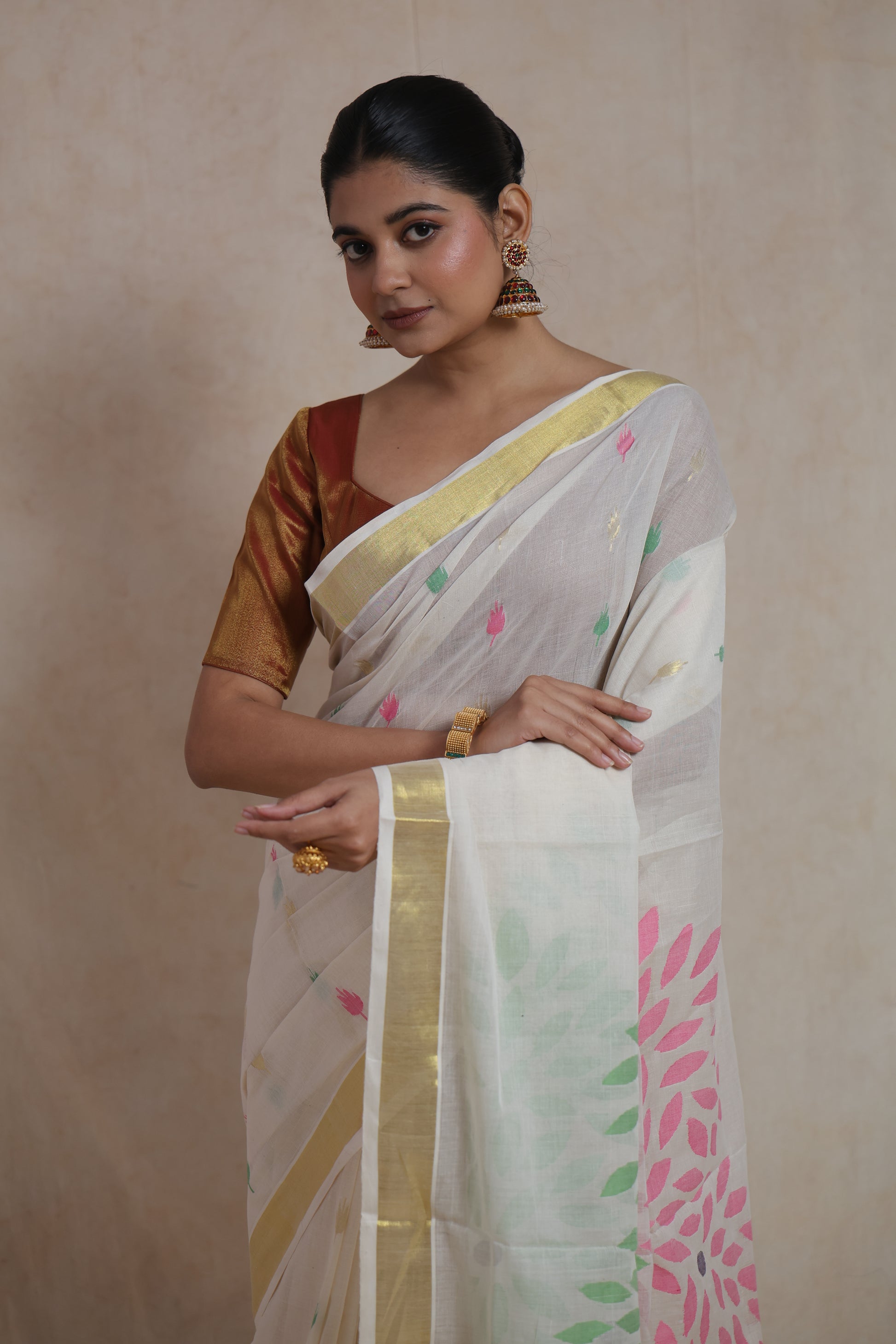 Handpainted floral and bird motif pallu on off white cotton saree