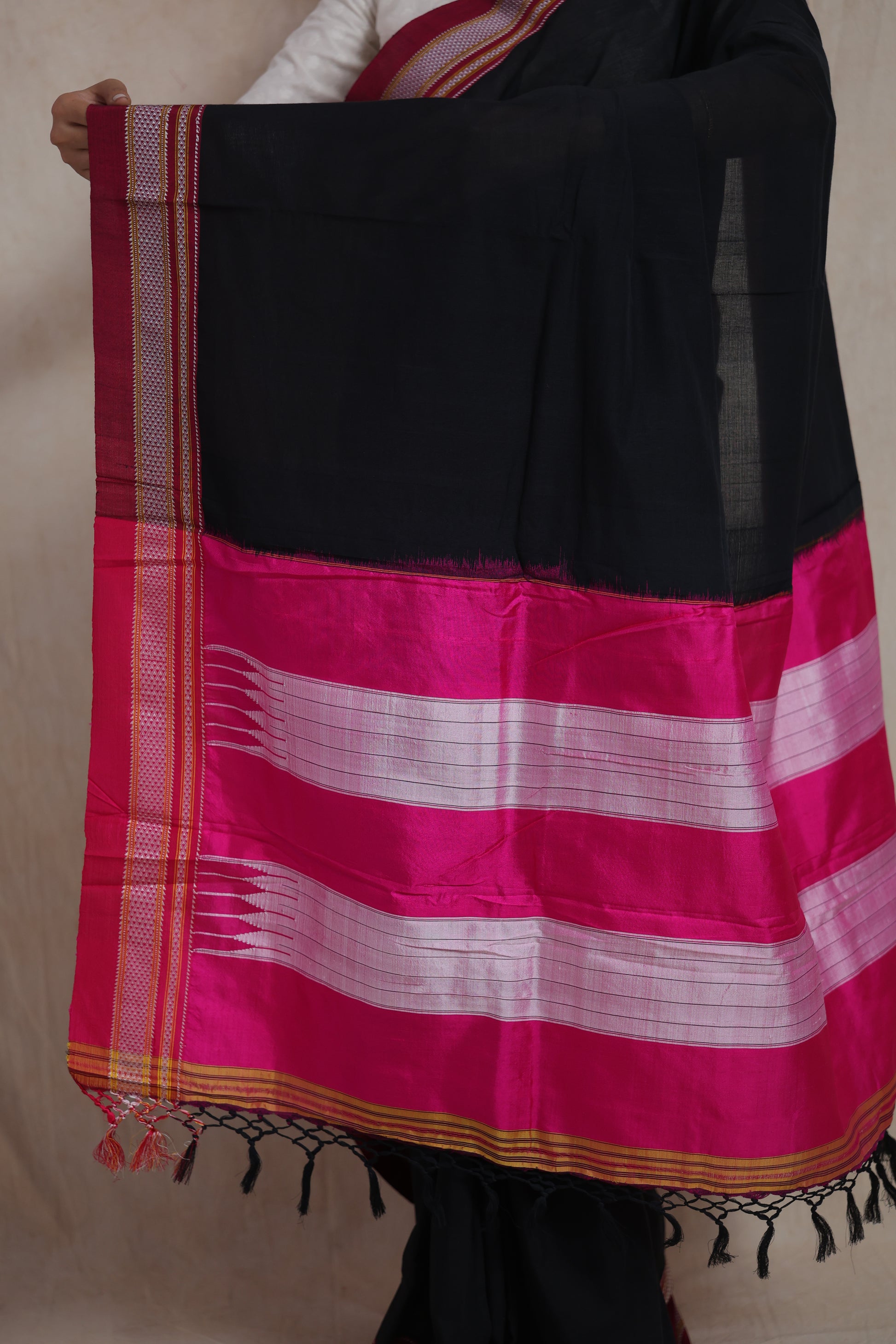 Close-up drape view of black Ilkal cotton saree with traditional border