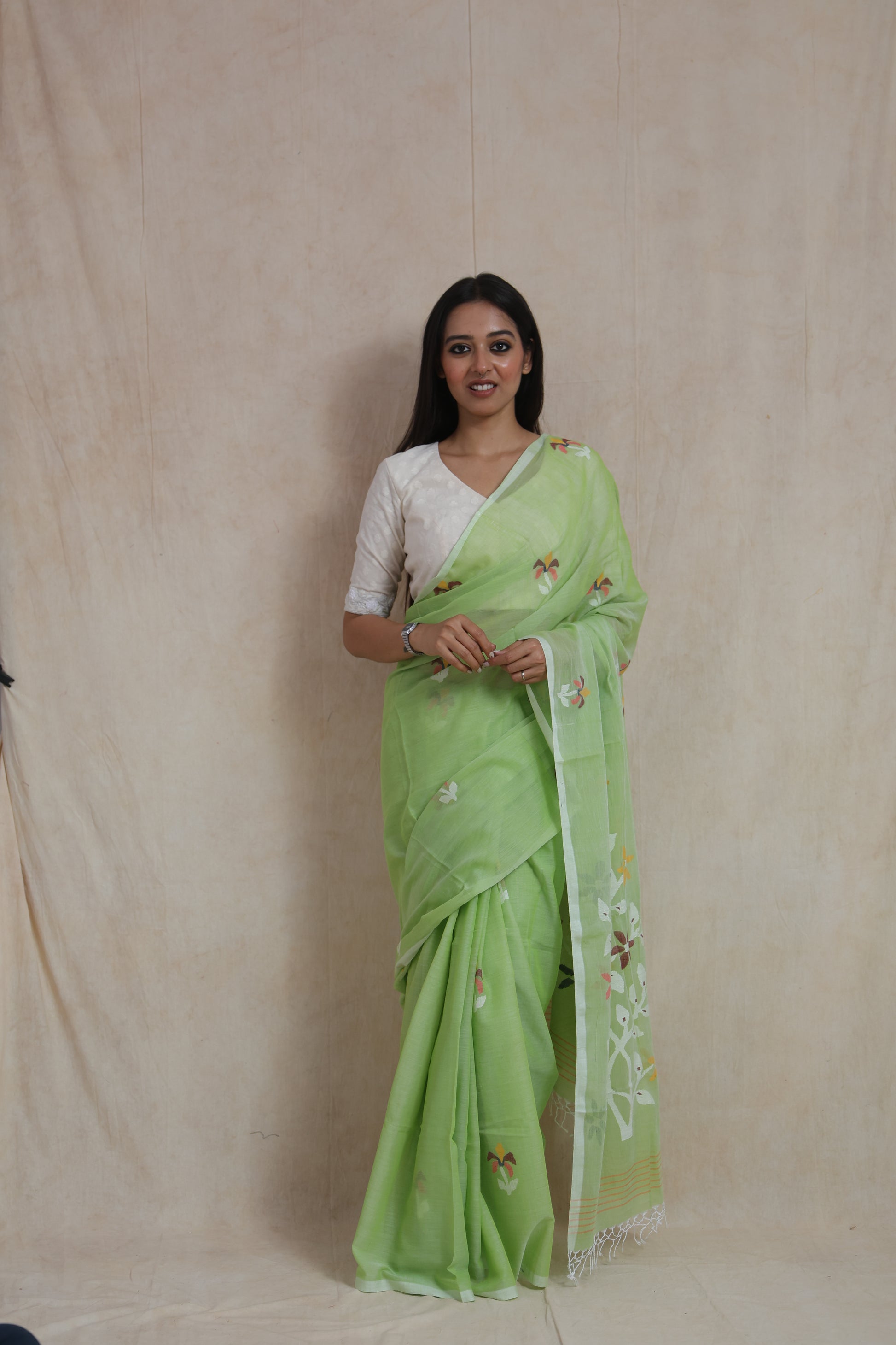 Front view of Bengal Cotton Fulia saree in pistachio green featuring floral Jamdani-inspired weaving