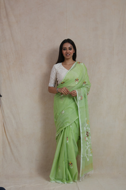 Front view of Bengal Cotton Fulia saree in pistachio green featuring floral Jamdani-inspired weaving