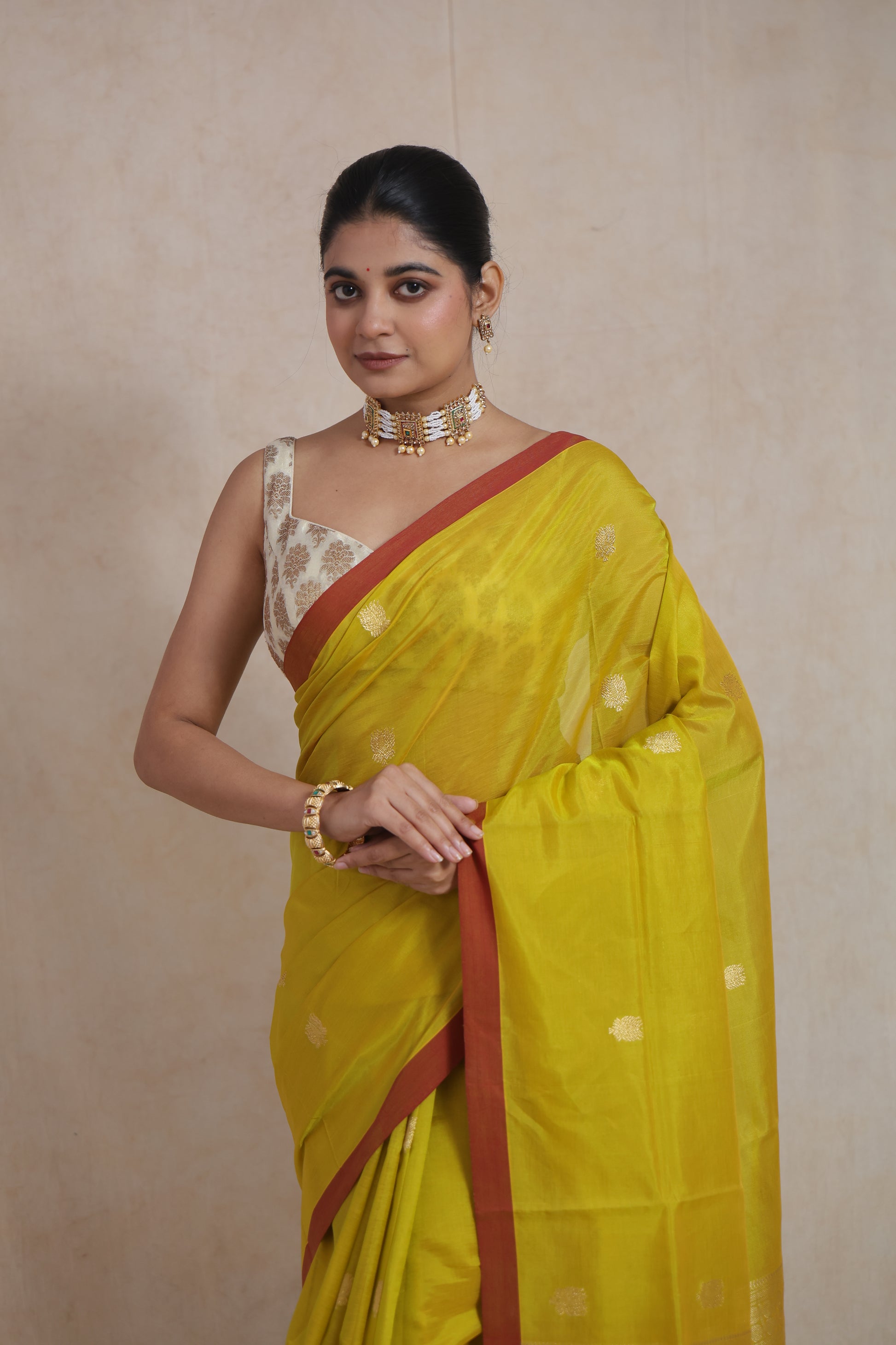 Close-up of lime yellow Kanchipuram Sico saree with delicate zari buttas