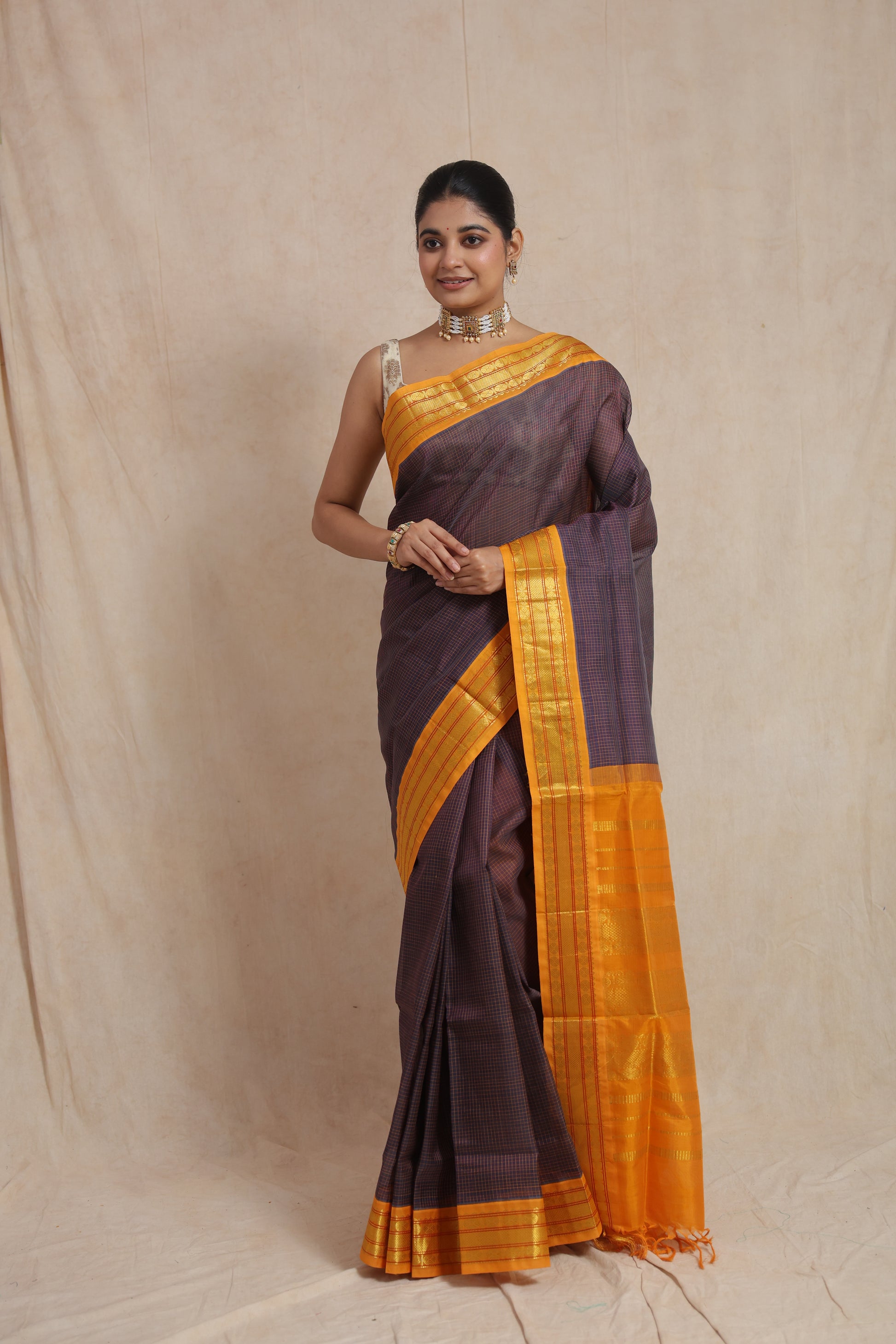 Full drape view of indigo Kanchipuram Sico saree with mustard zari border