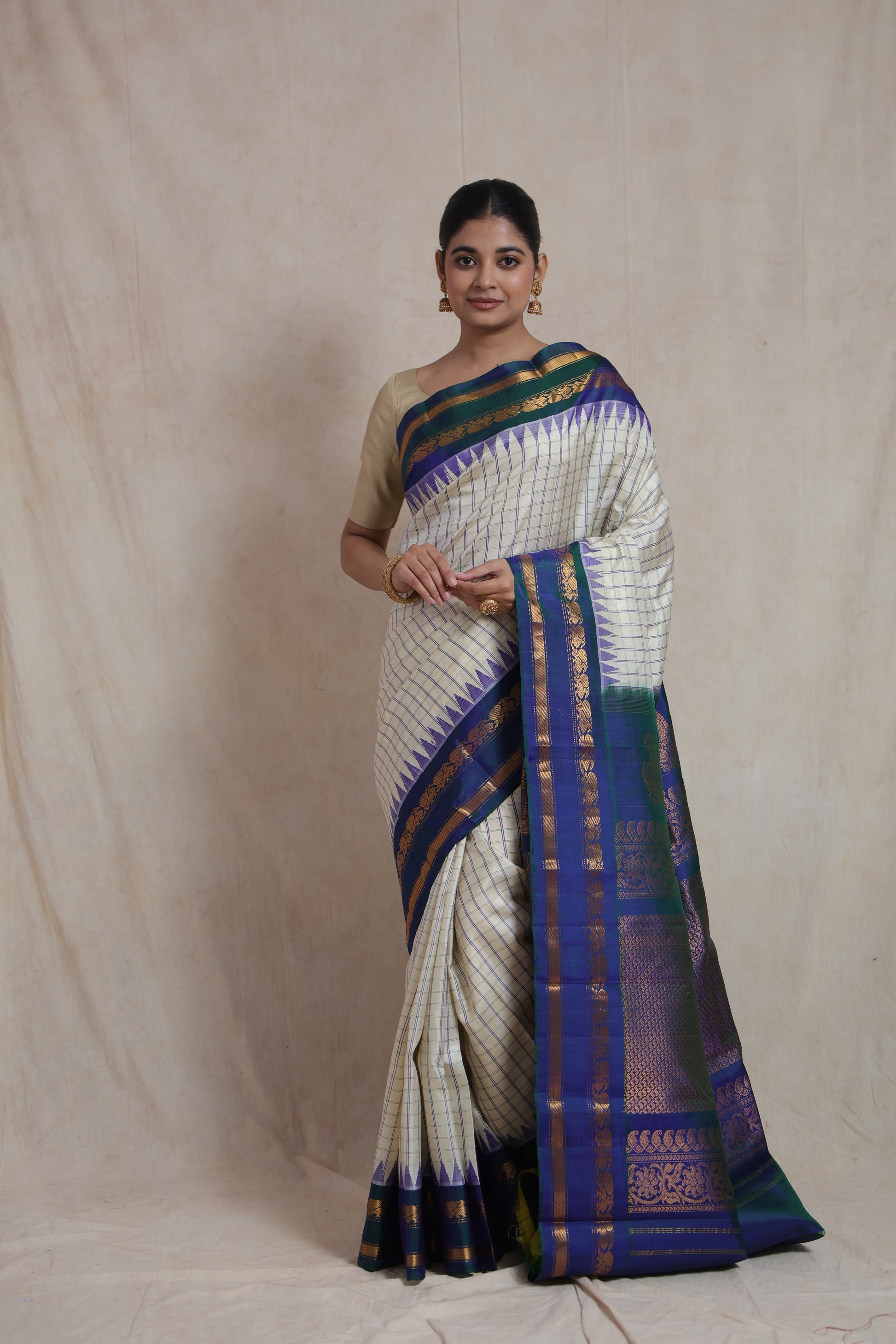 Front view of ivory Gadwal silk saree with royal blue woven pallu