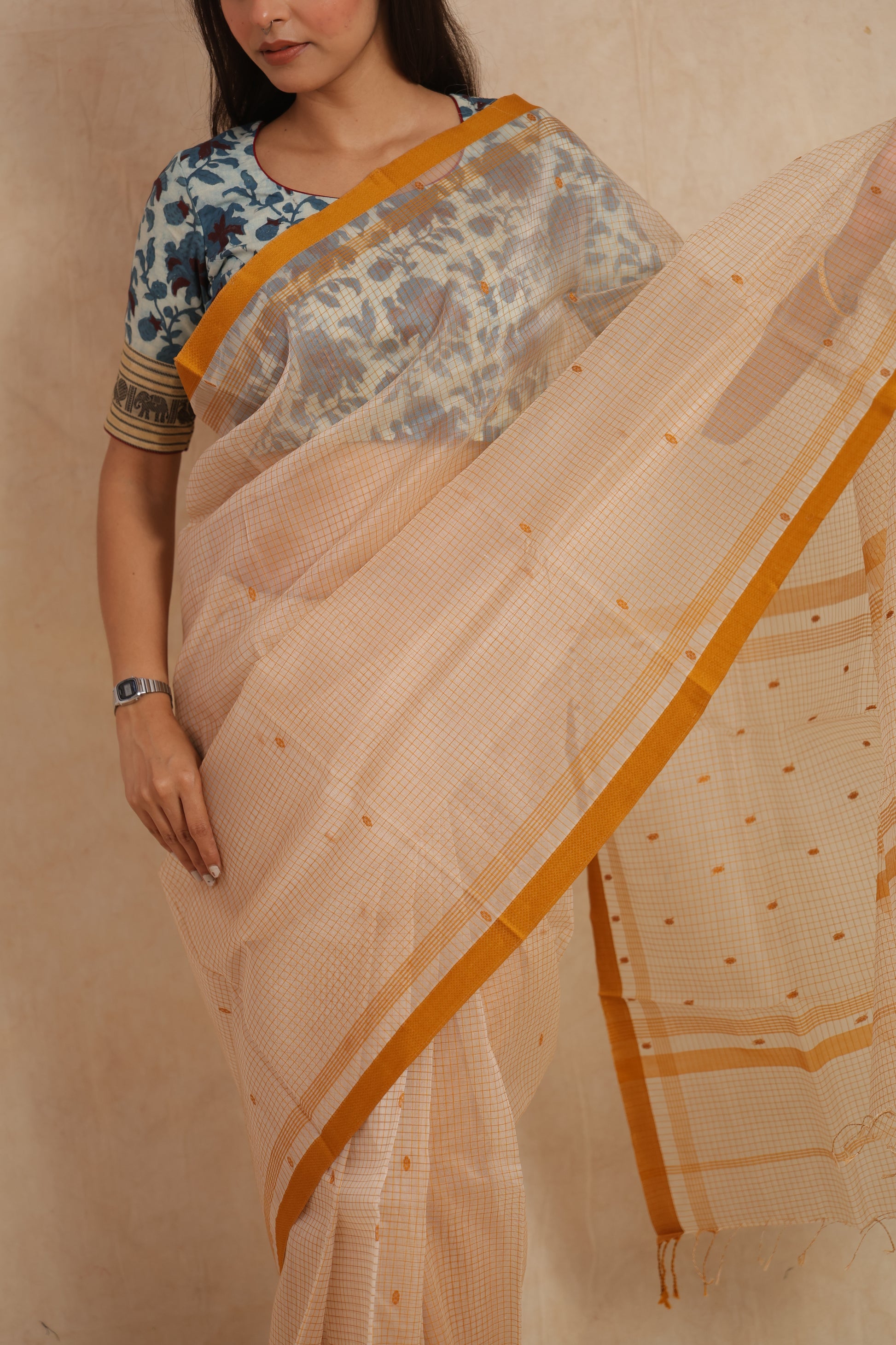 Close-up of ivory Maheshwari cotton saree with fine checks and mustard border