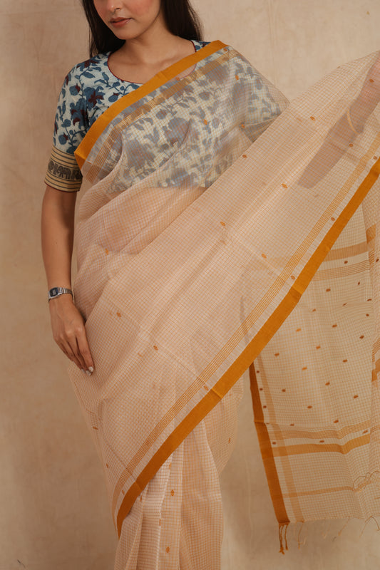 Close-up of ivory Maheshwari cotton saree with fine checks and mustard border
