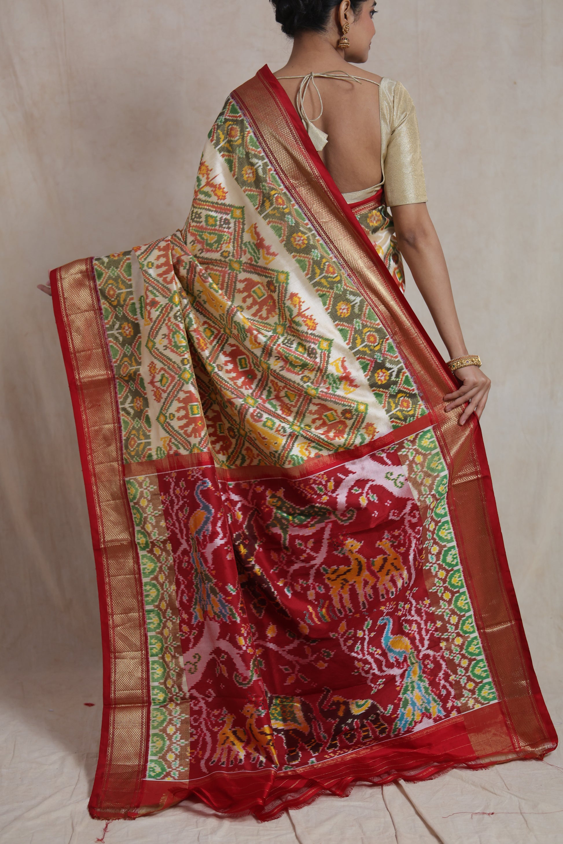 Back drape view of ivory and crimson Panchampali silk saree with traditional woven pallu
