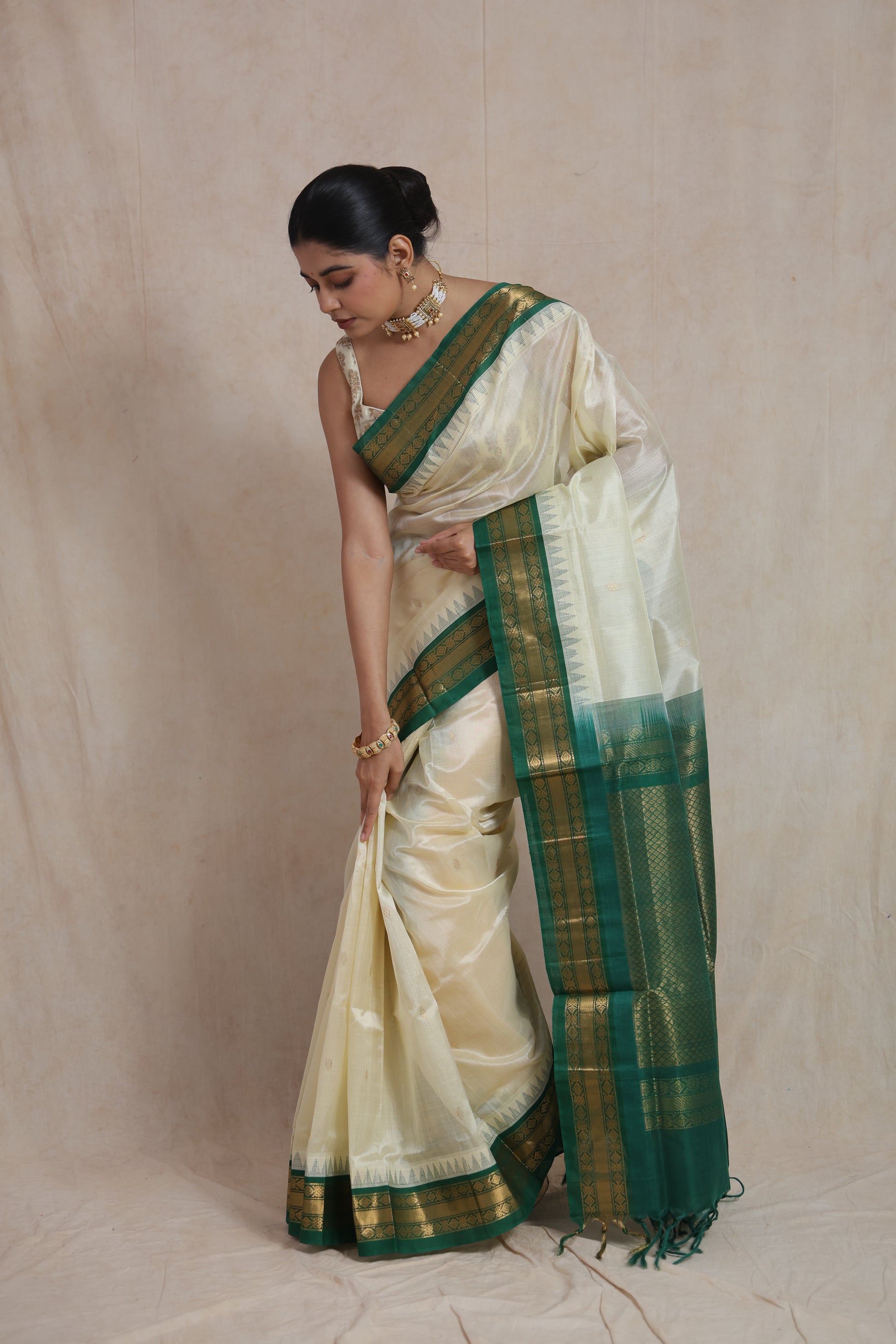 Portrait view of ivory Kanchipuram silk cotton saree with zari border