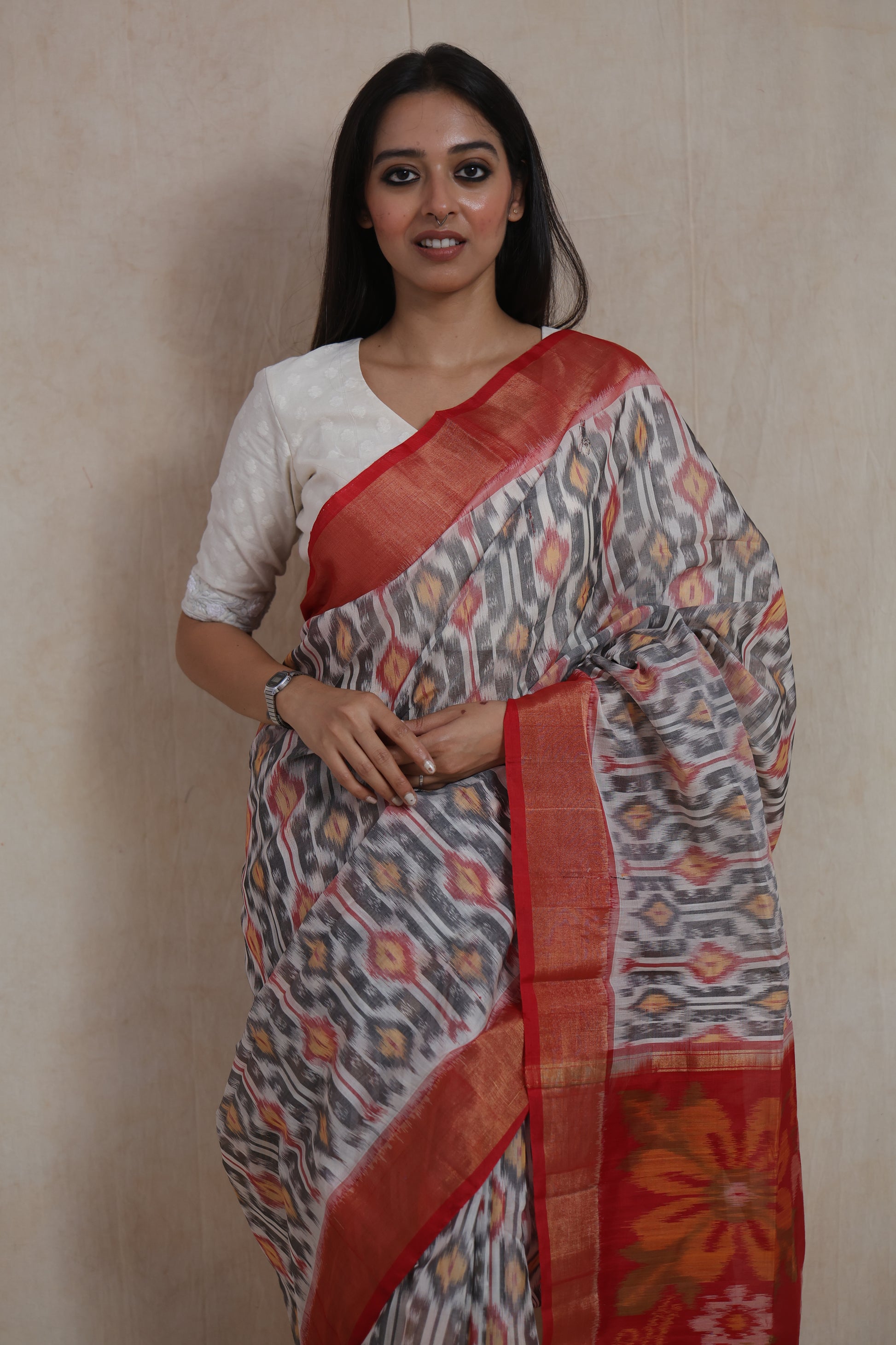 Elegant portrait view of ivory grey Pochampally SICO saree with crimson border and pallu
