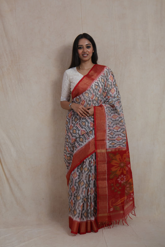 Front view of ivory grey Pochampally SICO saree with crimson floral pallu