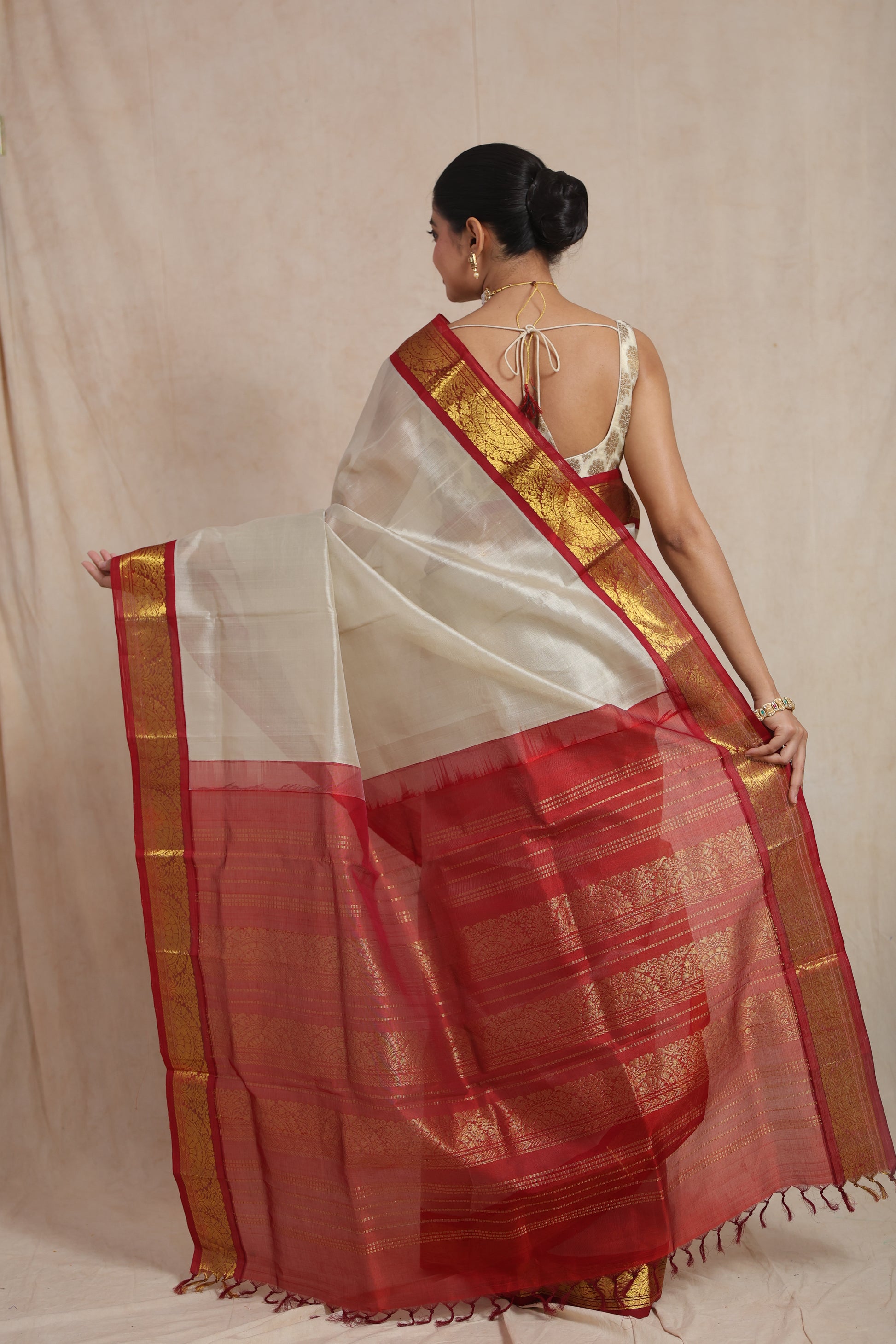 Close-up of crimson red zari woven border on ivory Kanchipuram Sico saree