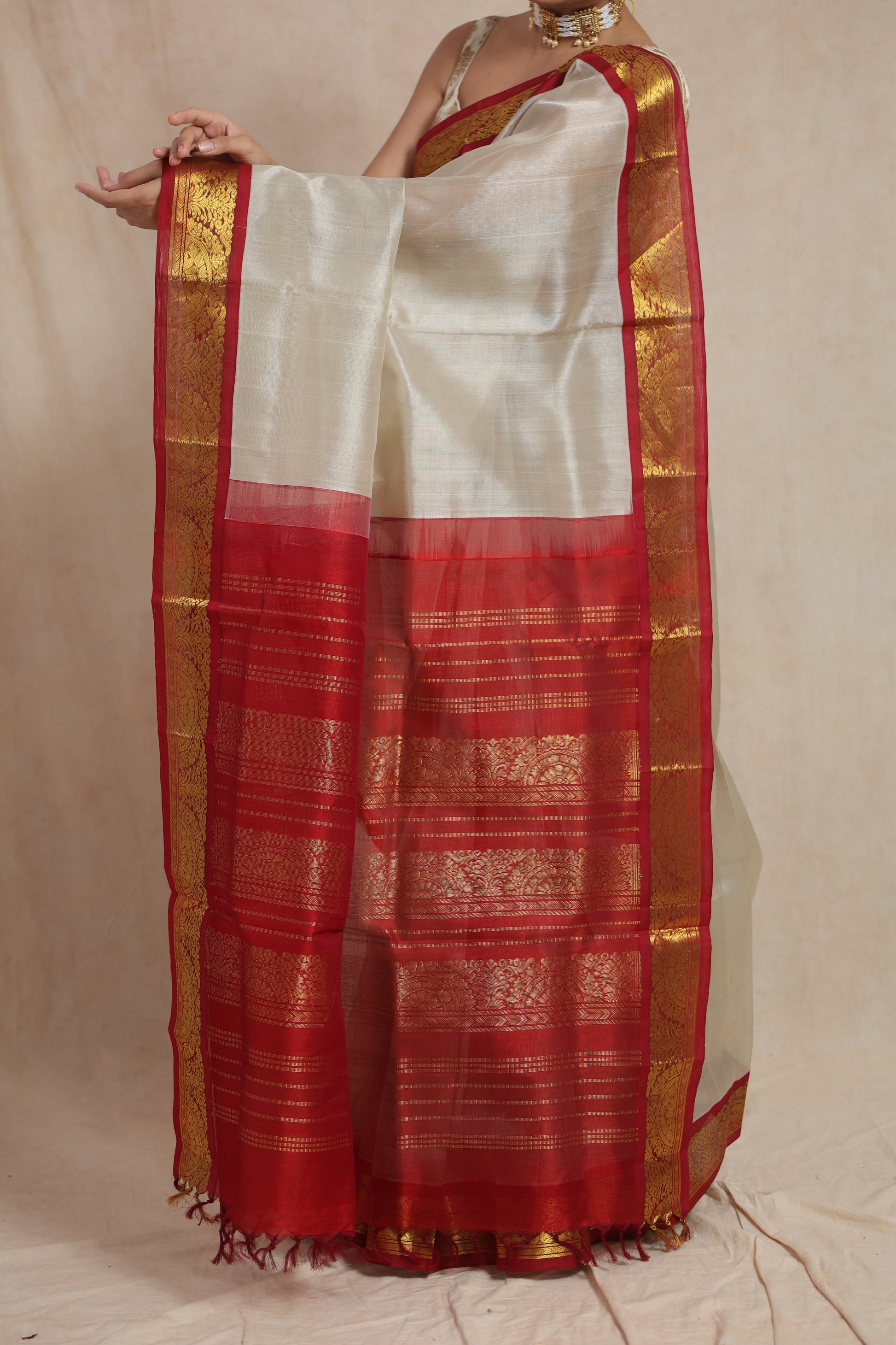 Detailed pallu view of ivory Kanchipuram Sico saree with rich red zari weaving