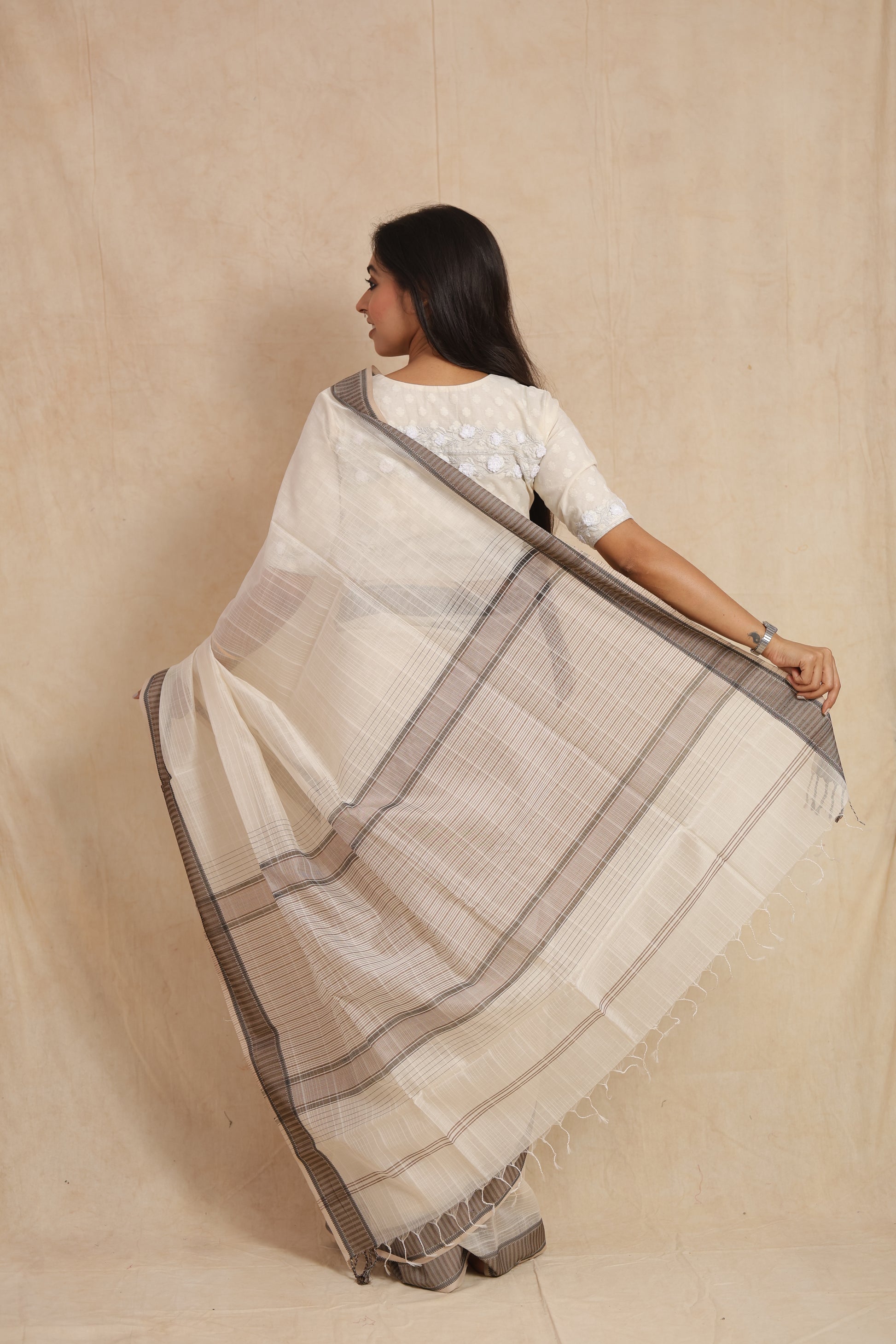 Back drape view of ivory Maheshwari silk tissue saree with detailed pallu