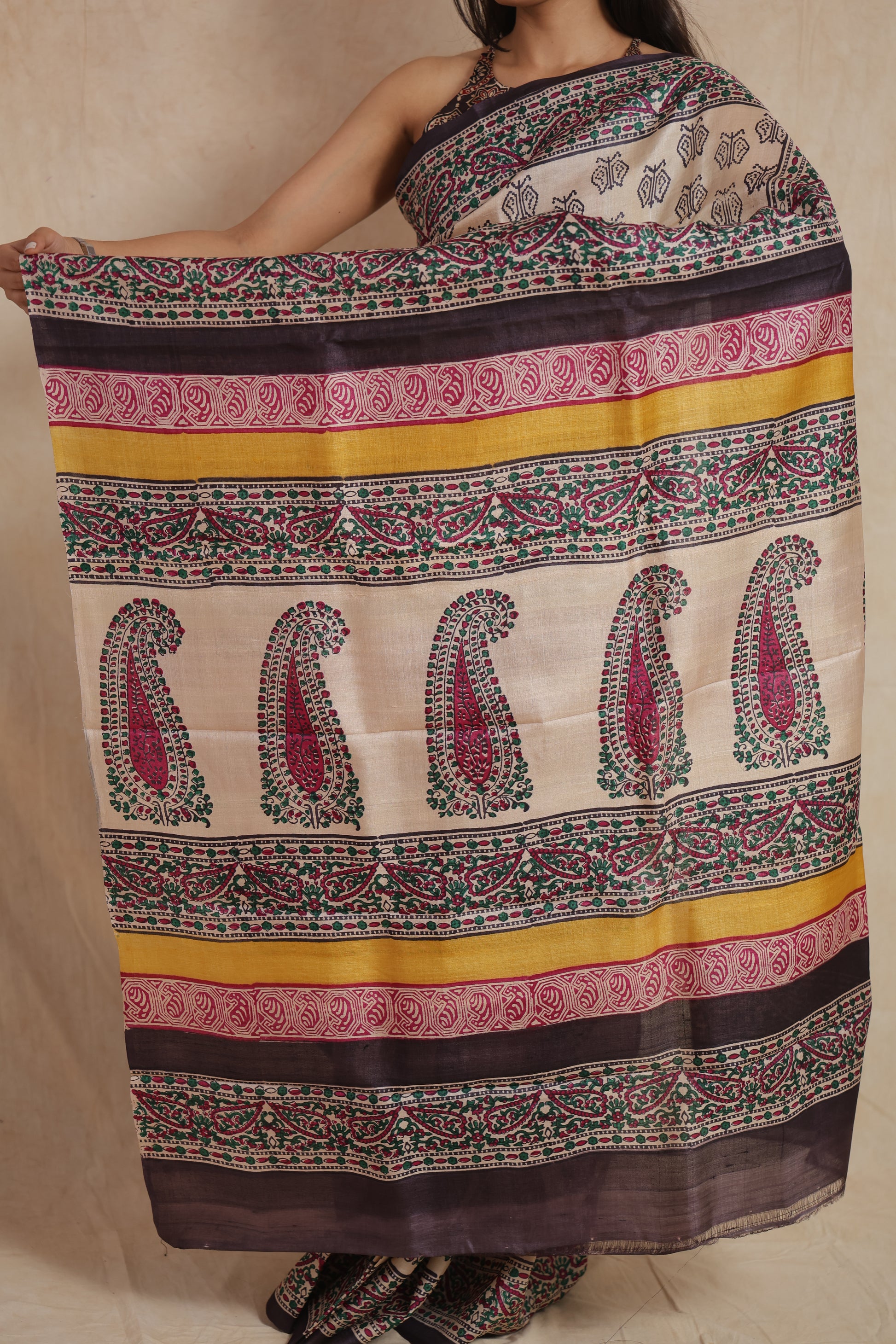 Detailed pallu design of ivory Tussar saree with paisley and striped prints