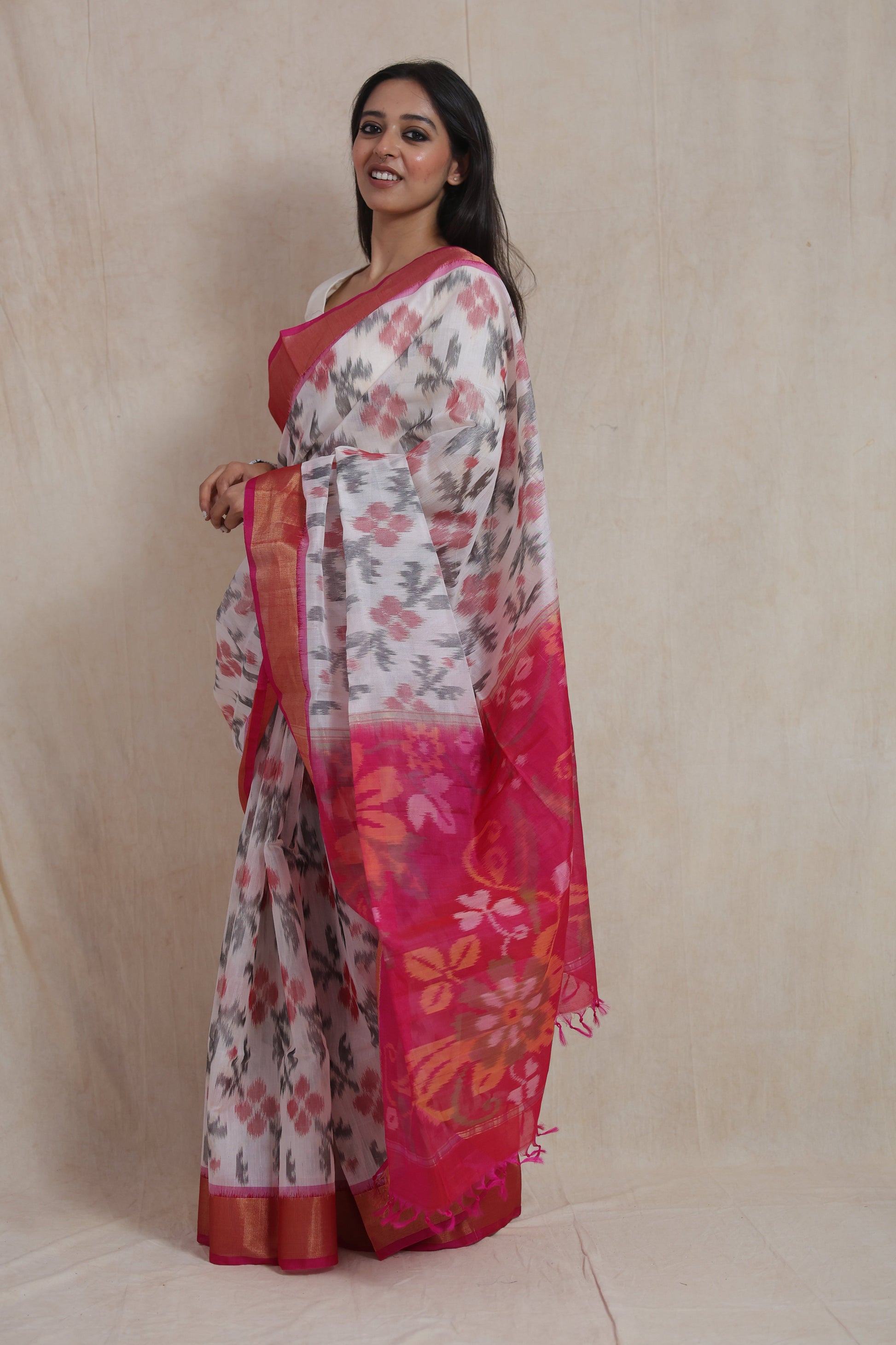 Side profile of ivory Panchampali handloom silk cotton saree with vibrant pink floral pallu and traditional weave detailing