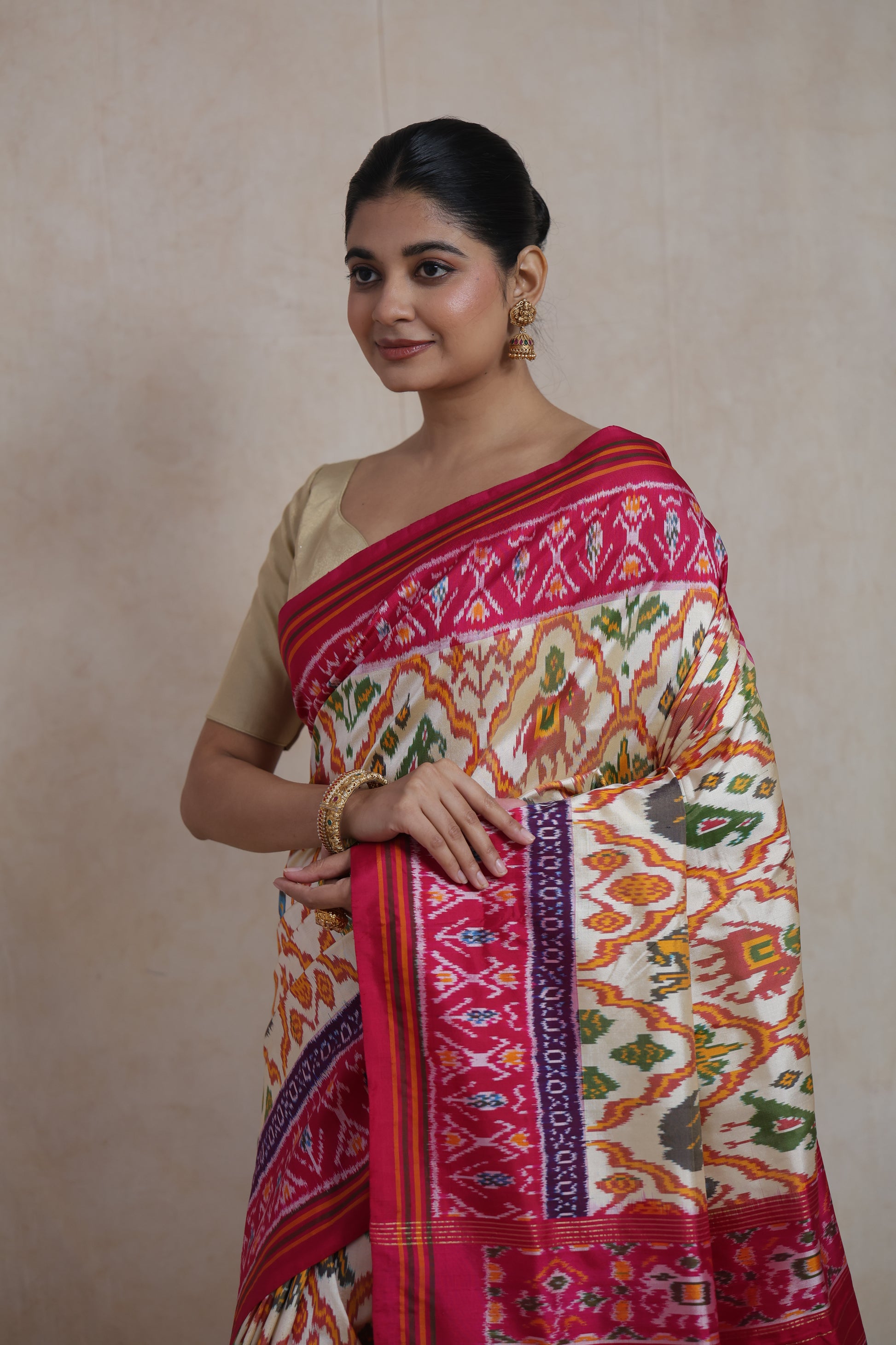 Elegant look in ivory Pochampally silk saree with artistic ikat motifs