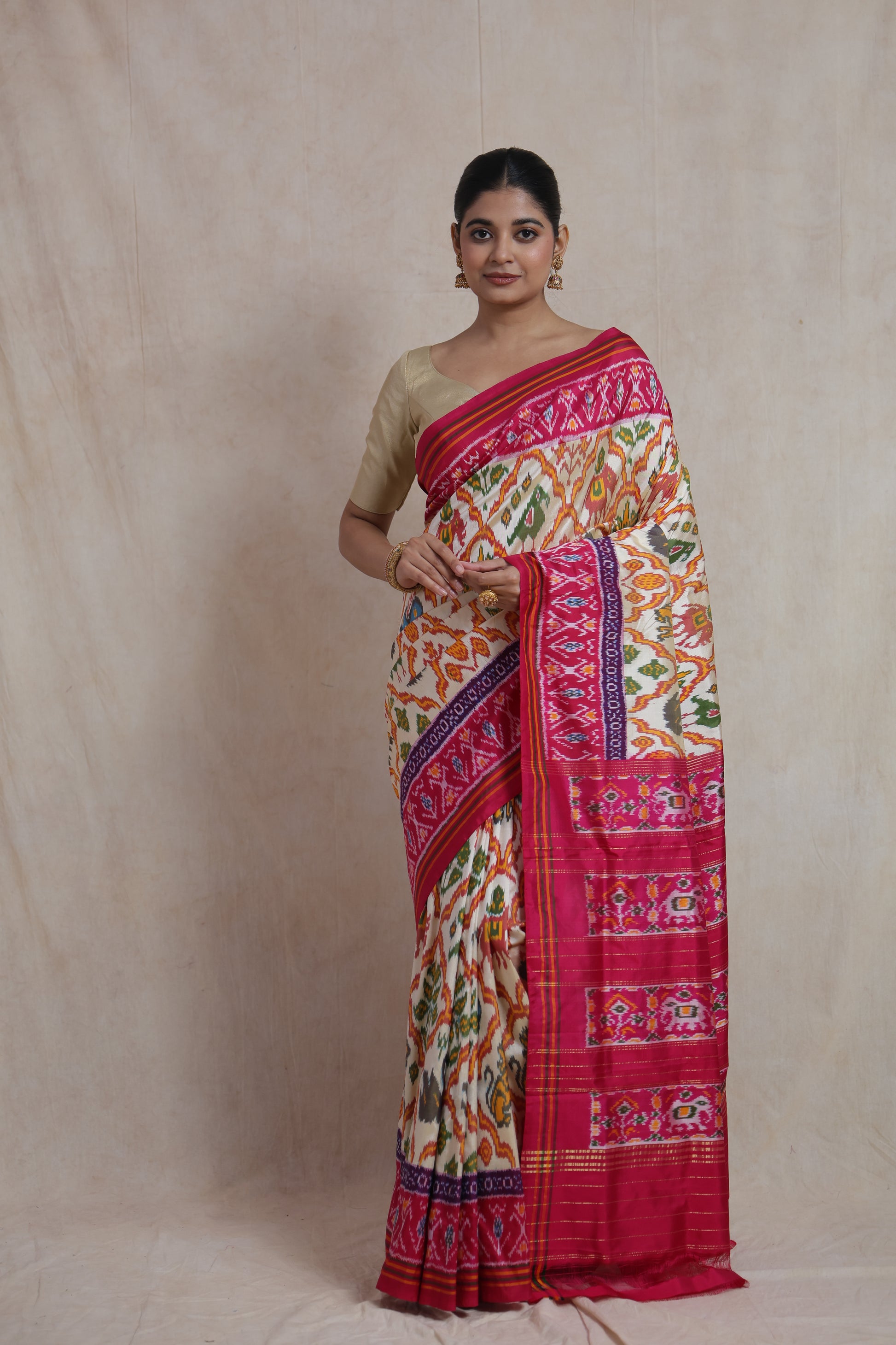 Full view of ivory Pochampally silk saree with rani pink border
