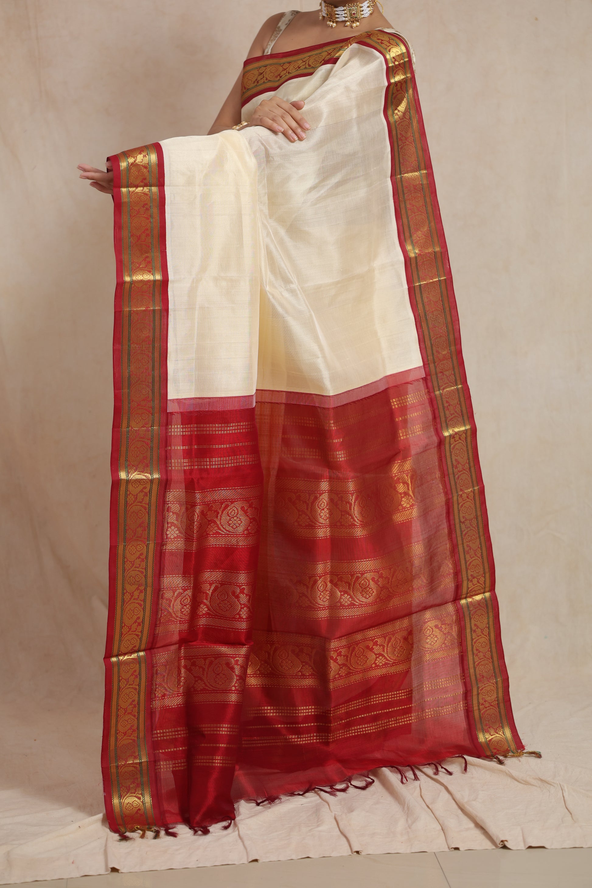 Detailed pallu view of ivory Kanchipuram Sico saree with red zari border
