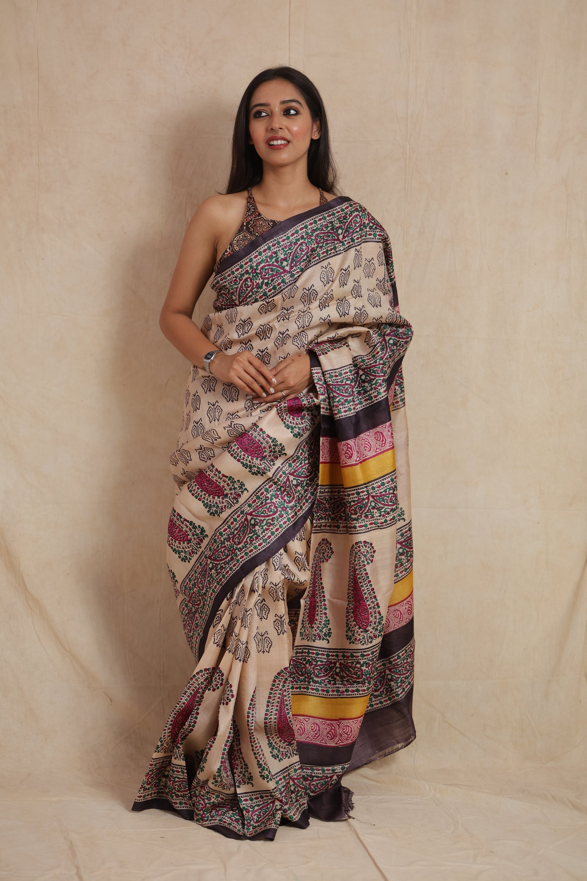 Front drape view of ivory Tussar print saree with artistic paisley motifs