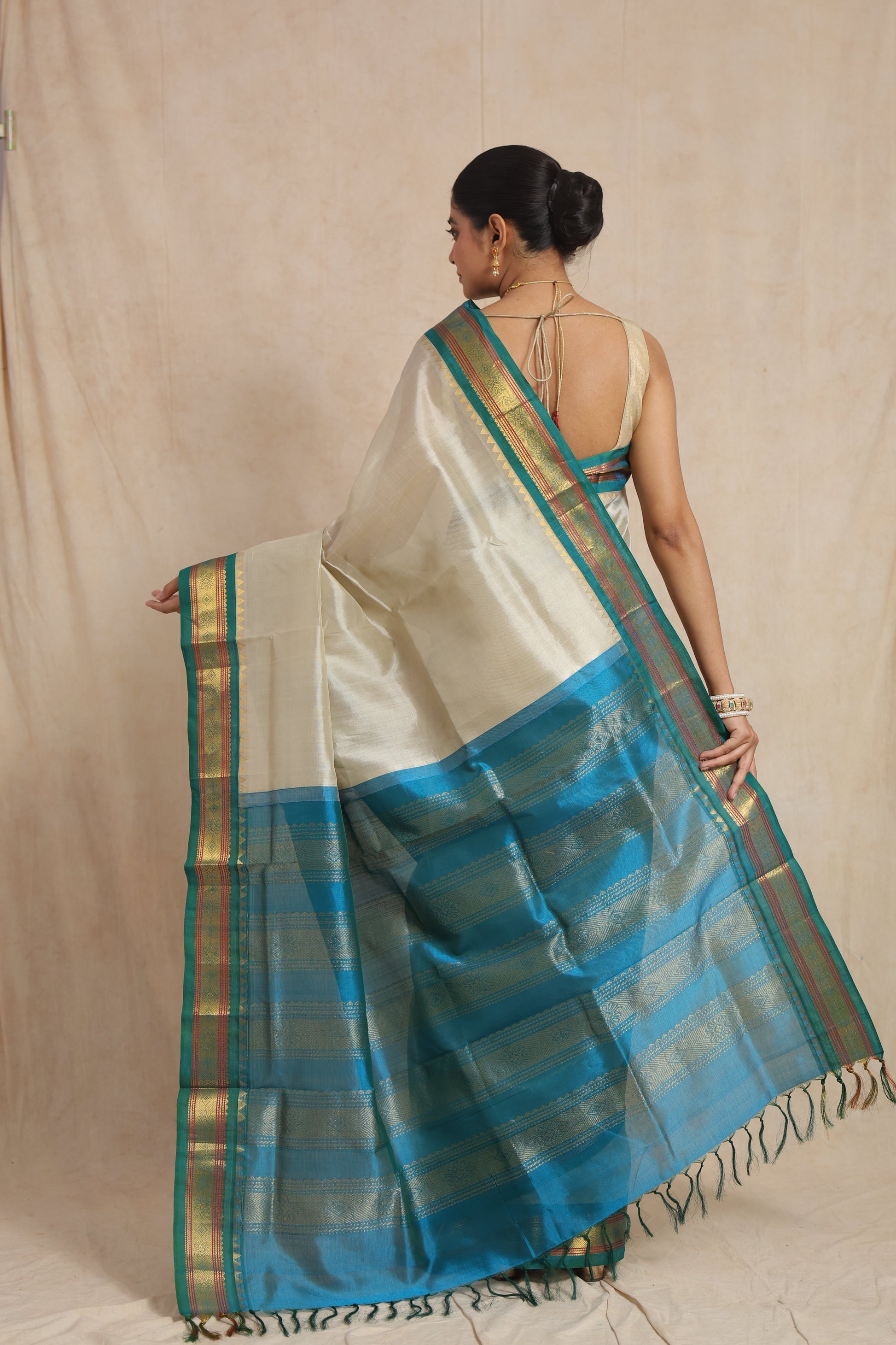 Back view of ivory white Kanchipuram Sico saree with teal blue zari woven pallu
