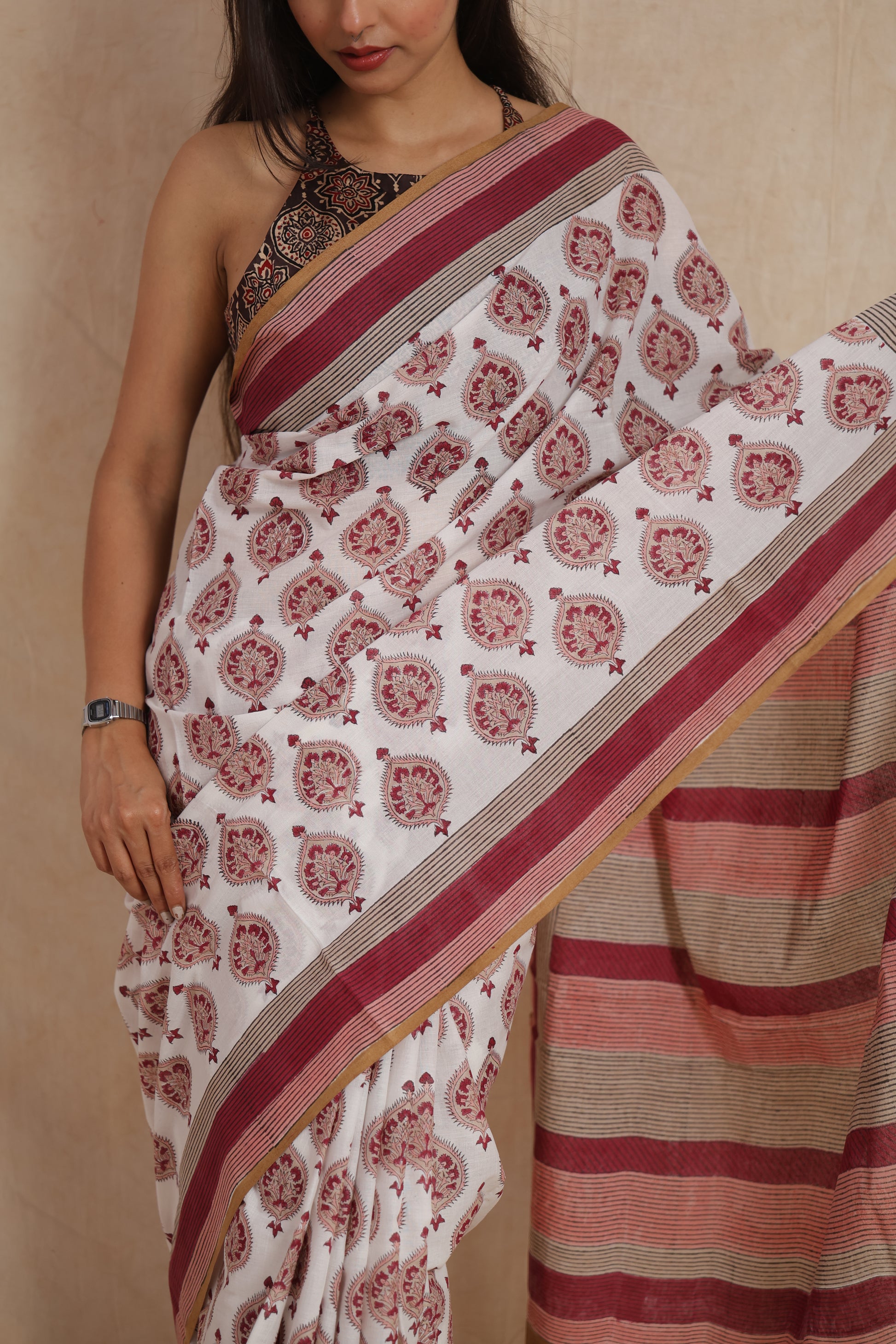 Close-up view of floral butta motifs on ivory white Sanghnaree cotton saree
