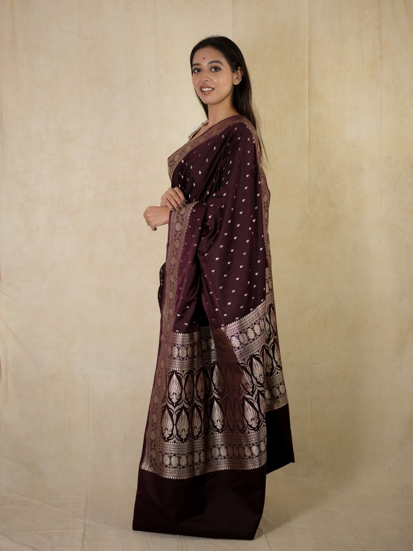 Dark brown Benarasi semi-silk saree with intricate traditional patterns and matching blouse piece, by Joyee Kolkata.