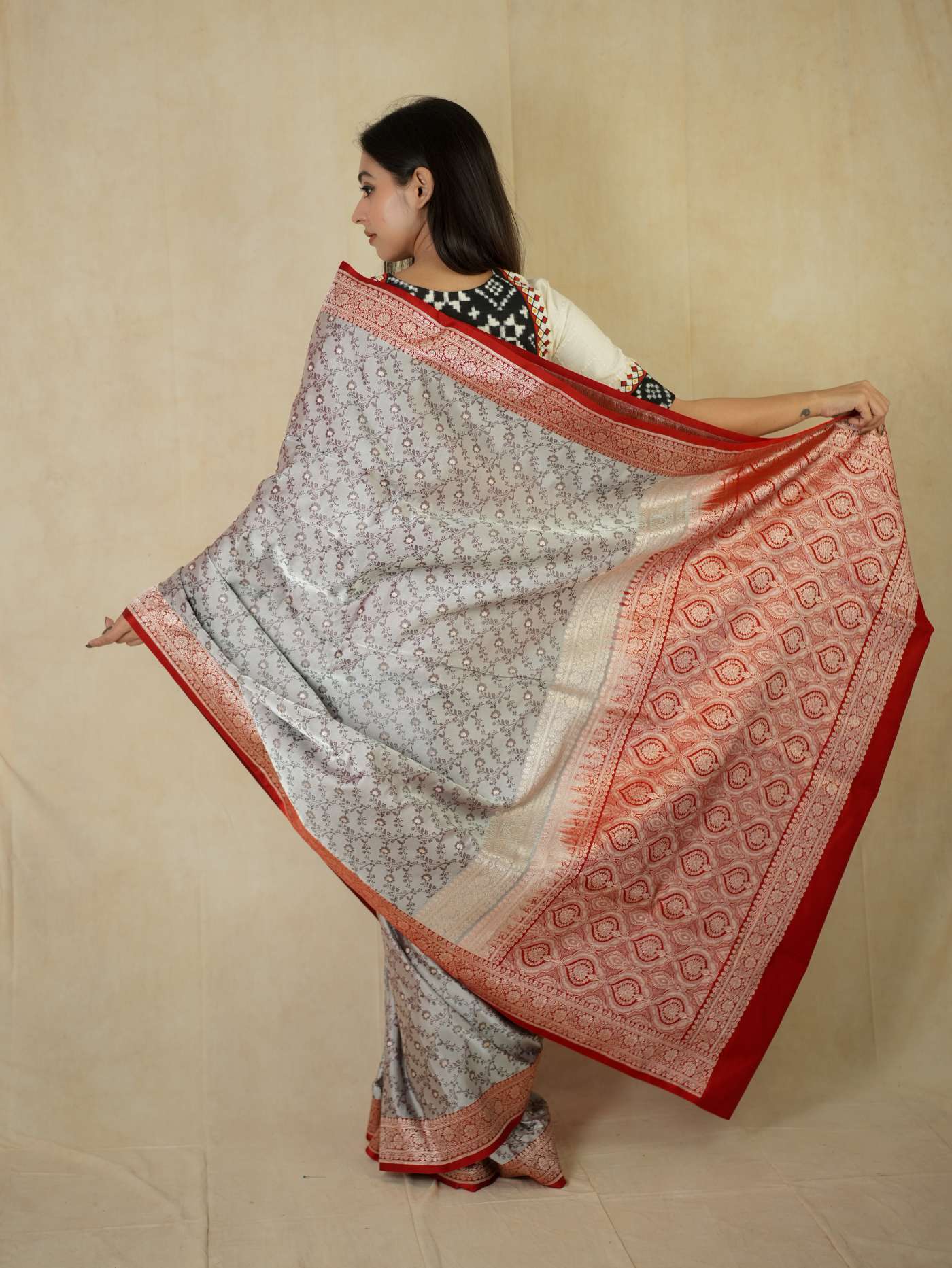 Grey semi Benarasi silk saree with intricate patterns and matching blouse piece by Joyee Kolkata.