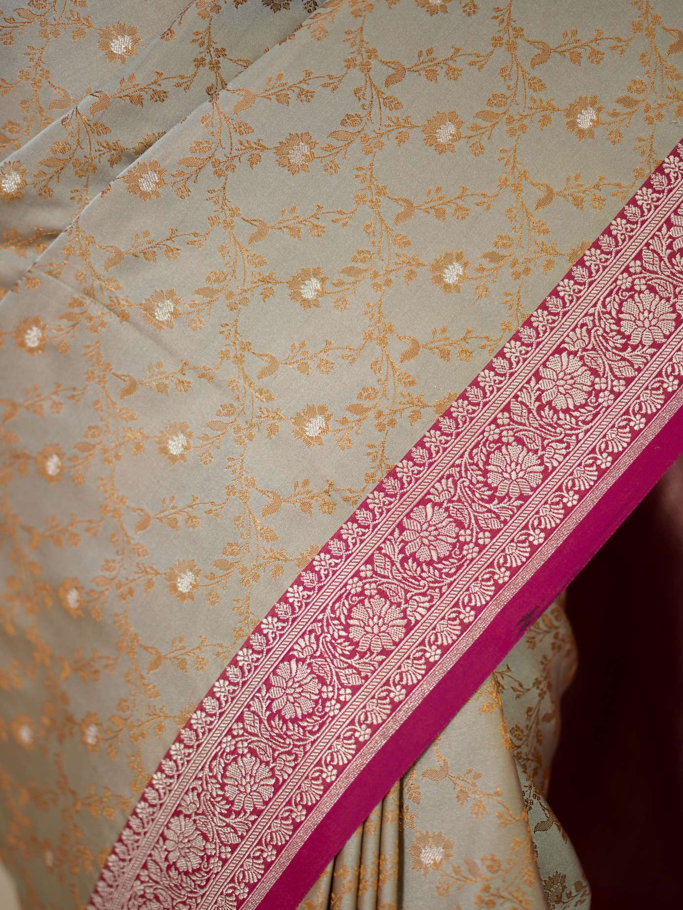 Grey semi-Benarasi silk saree with intricate patterns and matching blouse piece from Joyee Kolkata, elegant traditional Indian attire.