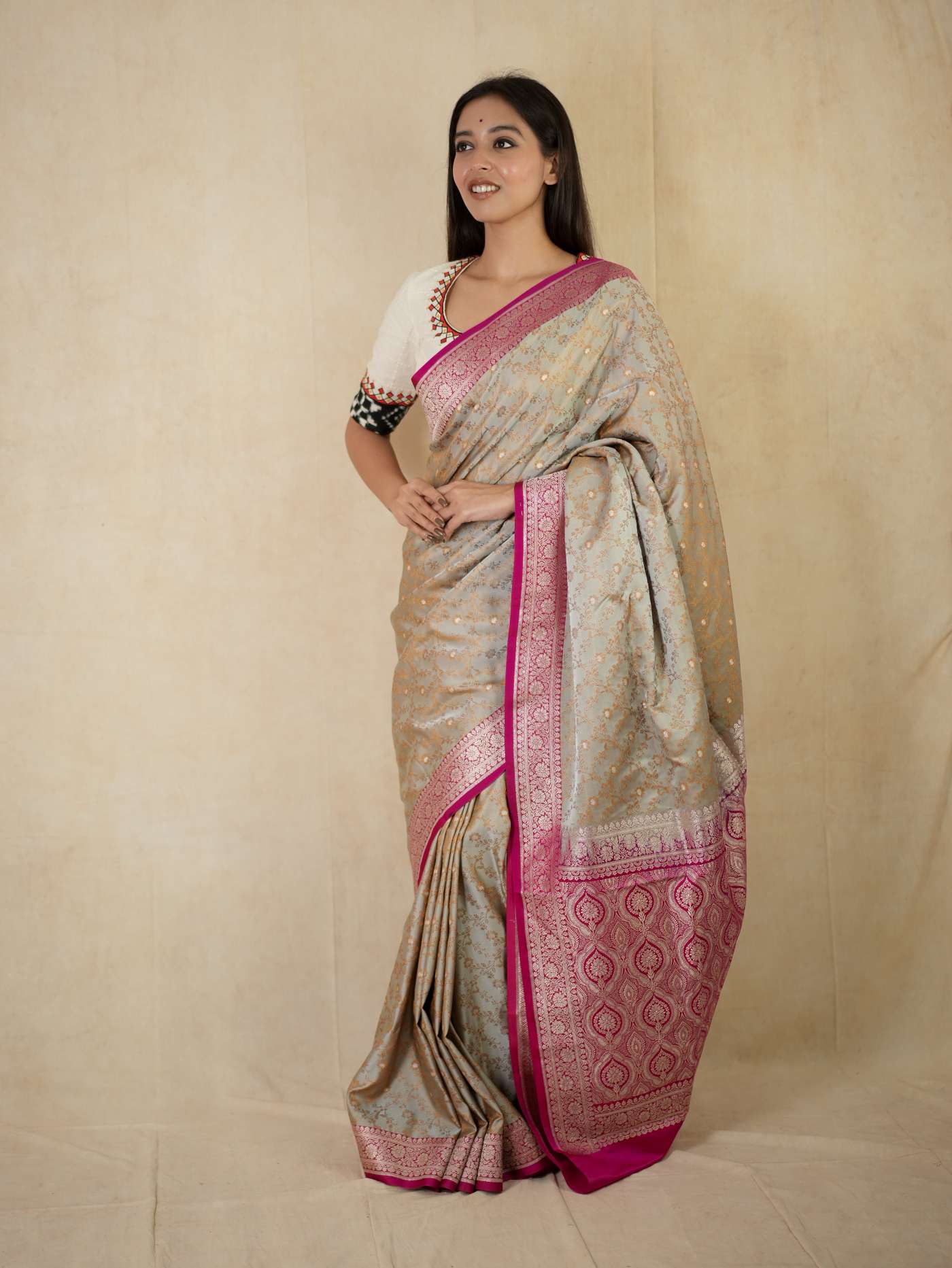 Grey semi Benarasi silk saree with intricate patterns and matching blouse piece, traditional Indian attire by Joyee Kolkata.
