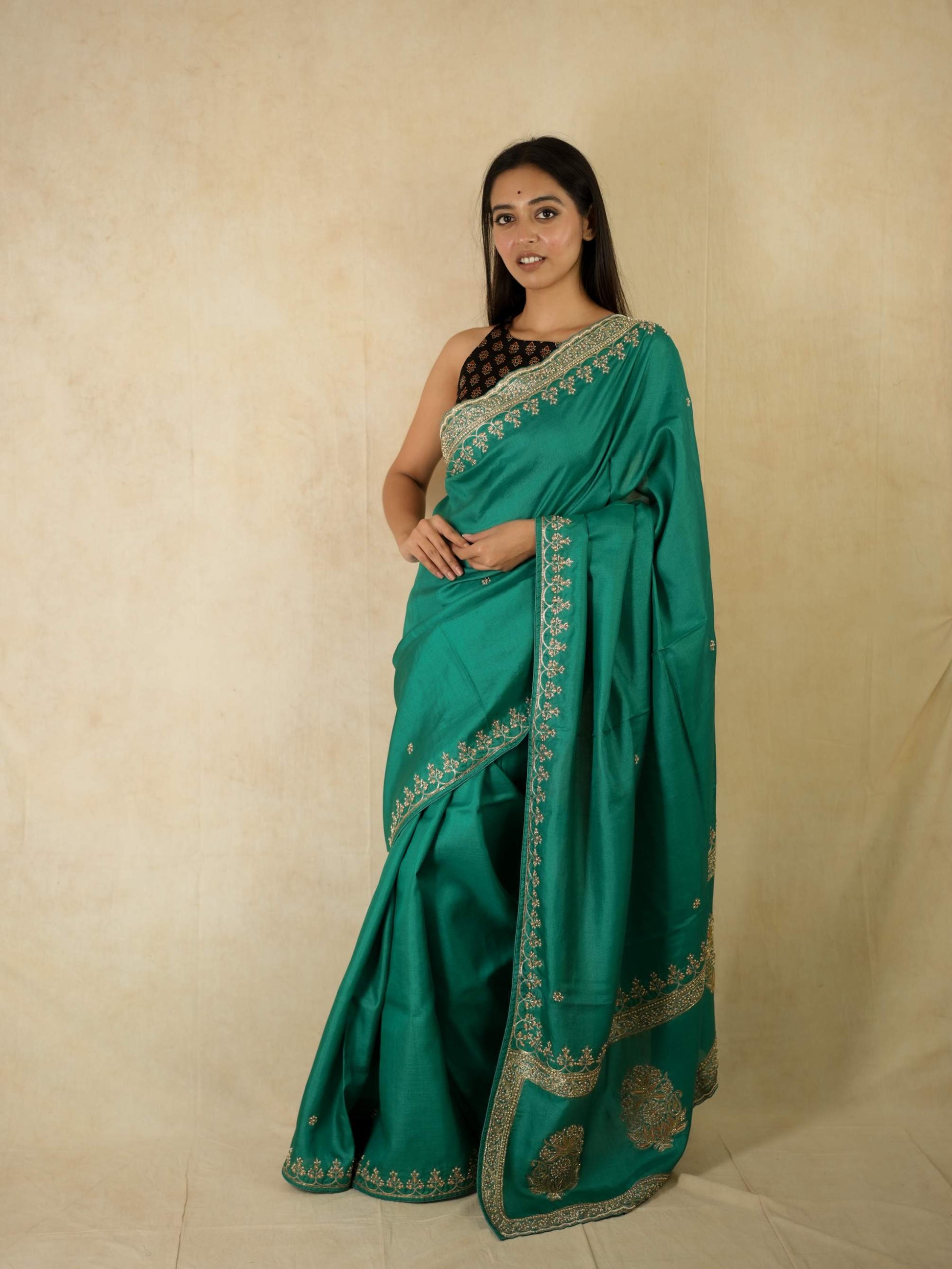 Hand Zardosi green Tussar silk saree with intricate embroidery and matching blouse piece from Joyee Kolkata.