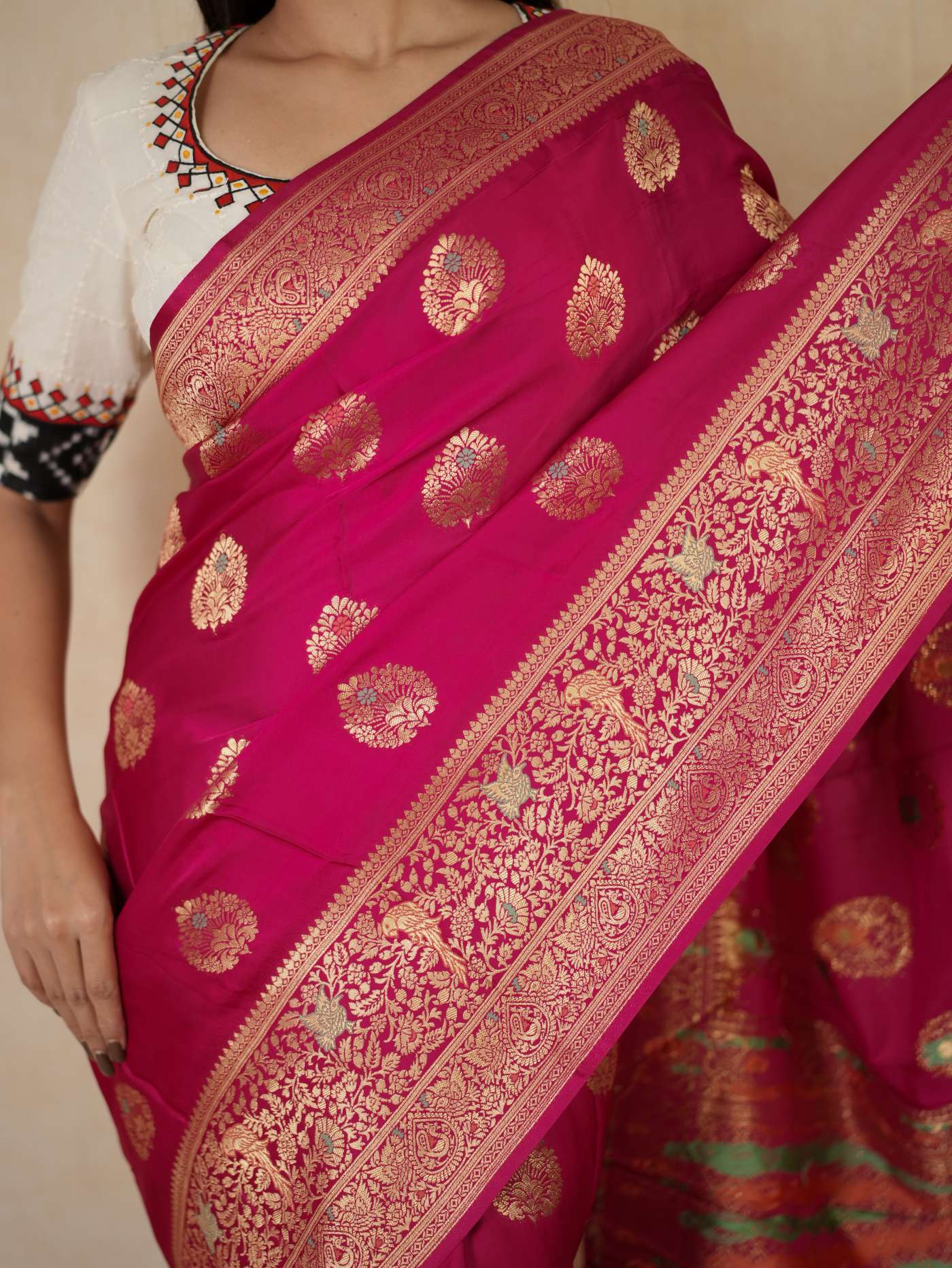 Magenta semi-silk Benarasi saree with intricate patterns and a matching 1-meter blouse piece by Joyee Kolkata.
