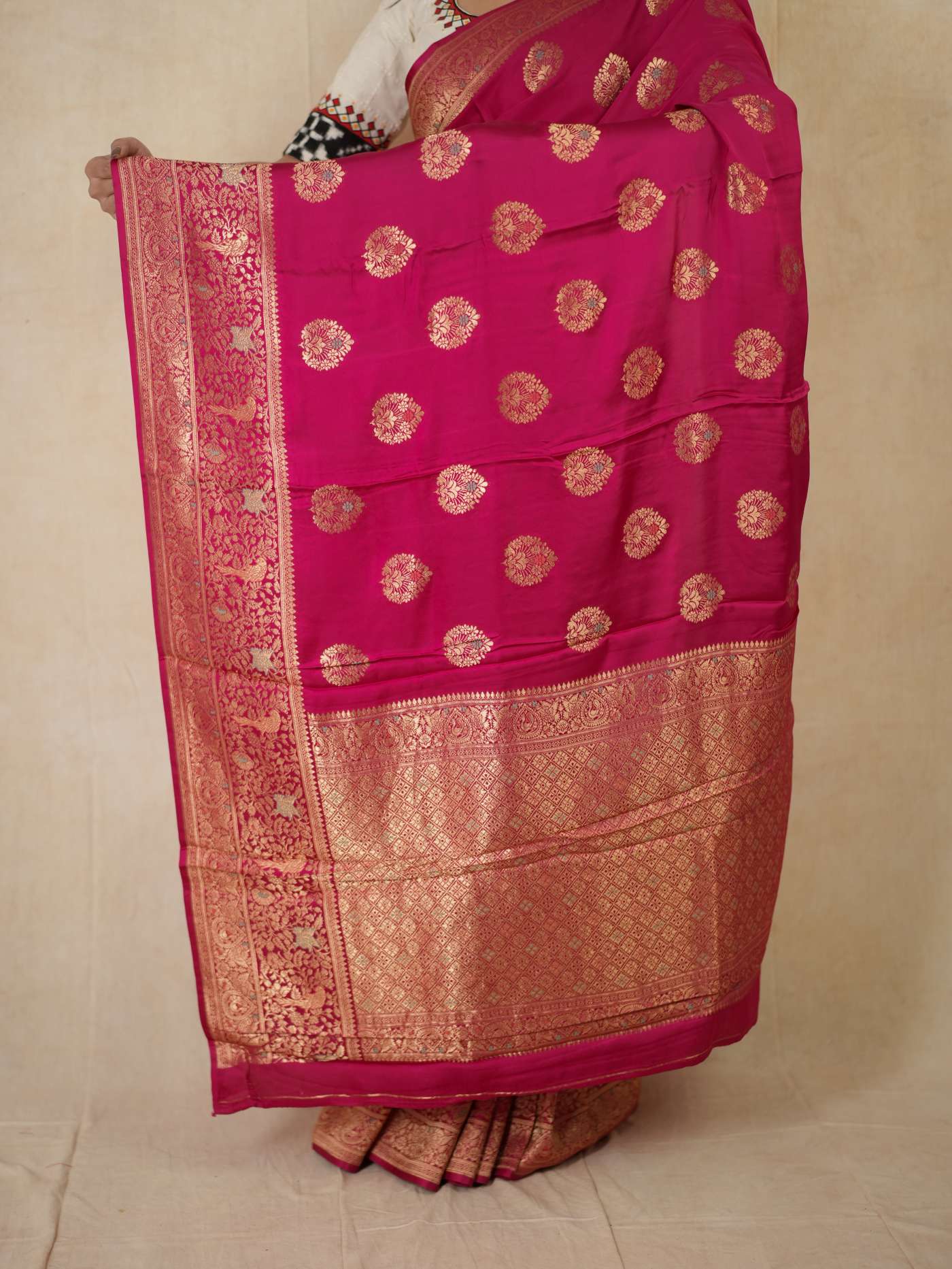 Magenta Benarasi semi-silk saree with intricate patterns and matching blouse piece from Joyee Kolkata, displayed flat.