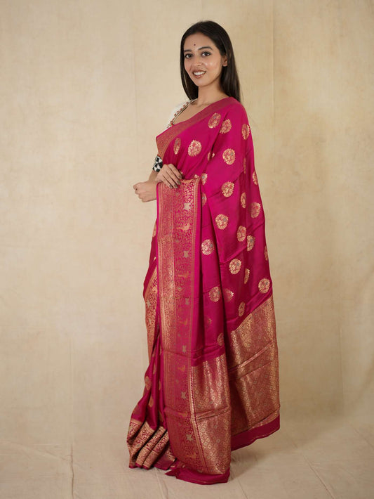 Magenta Benarasi semi silk saree with intricate gold zari work and matching blouse piece, designed by Joyee Kolkata.