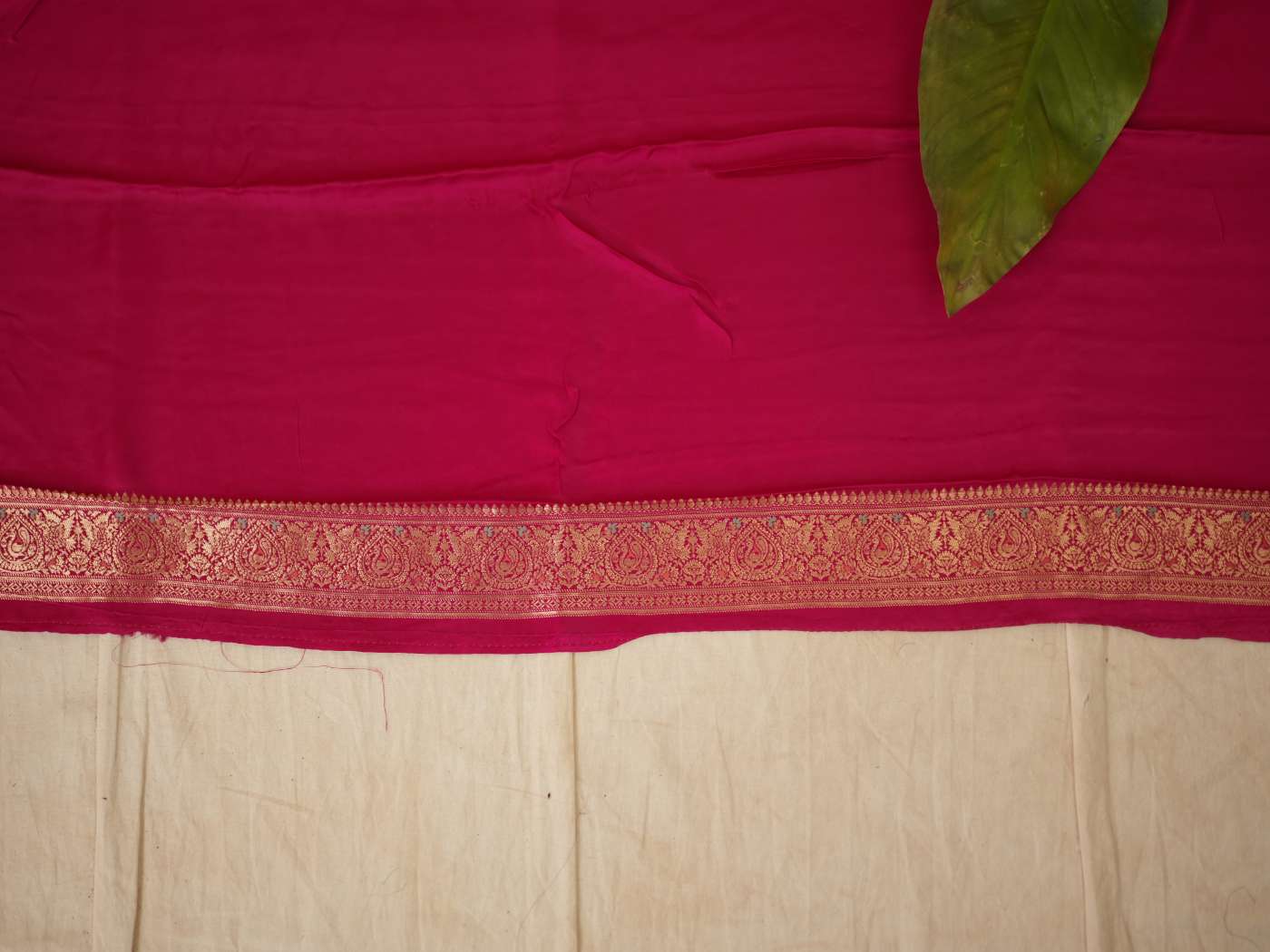 Magenta semi-silk Benarasi saree with intricate gold zari work and matching blouse piece, stylish traditional Indian attire.