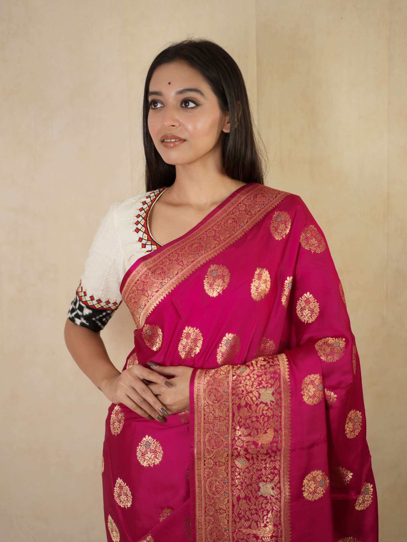 Magenta semi-silk Benarasi saree with intricate gold work, paired with a matching 1-meter blouse piece from Joyee Kolkata.