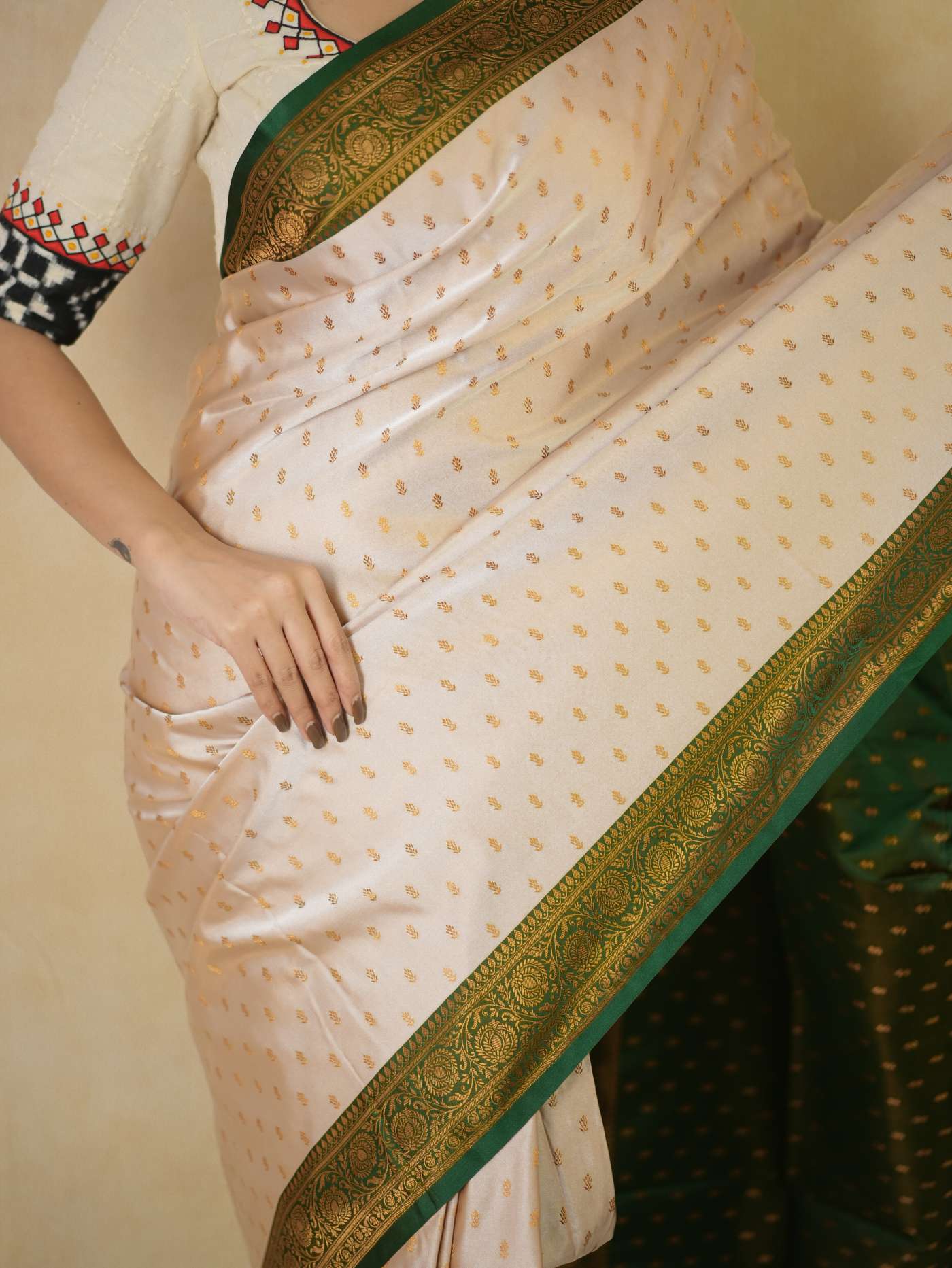 Cream semi-Benarasi silk saree by Joyee Kolkata with intricate design and 88 cm blouse piece, displayed on a mannequin.