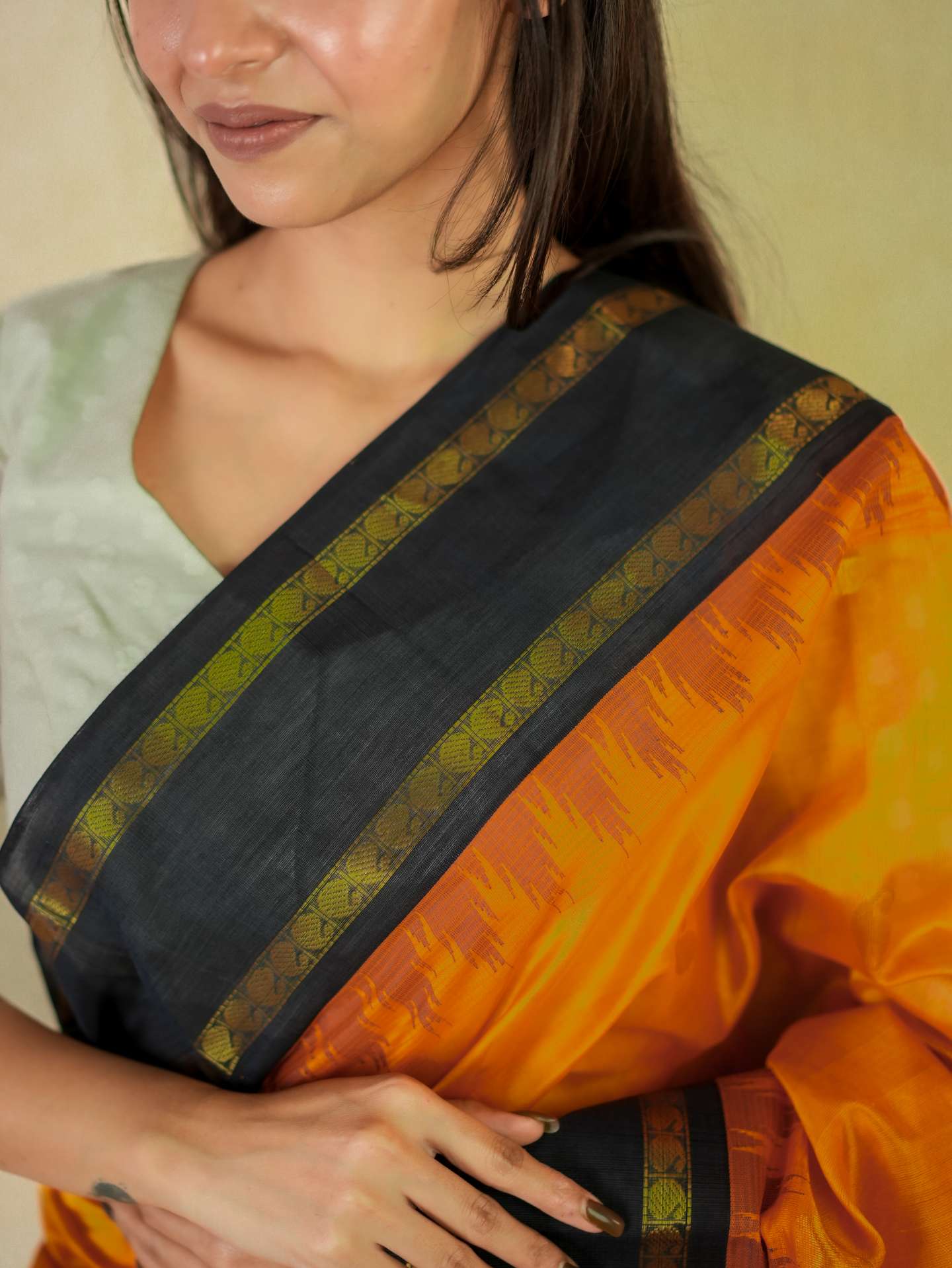 Orange Kanchipuram silk saree by Joyee Kolkata with 86 cm blouse piece, featuring traditional gold zari work and intricate patterns.