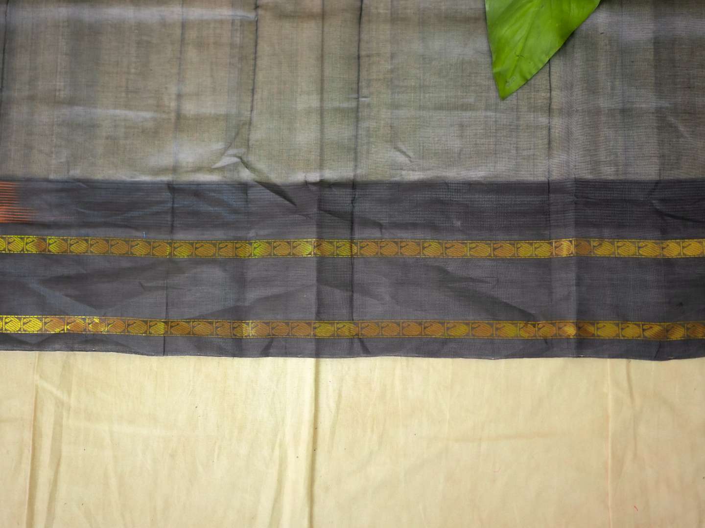 Orange Kanchipuram silk saree by Joyee Kolkata with matching blouse piece, featuring traditional gold zari work and intricate patterns.