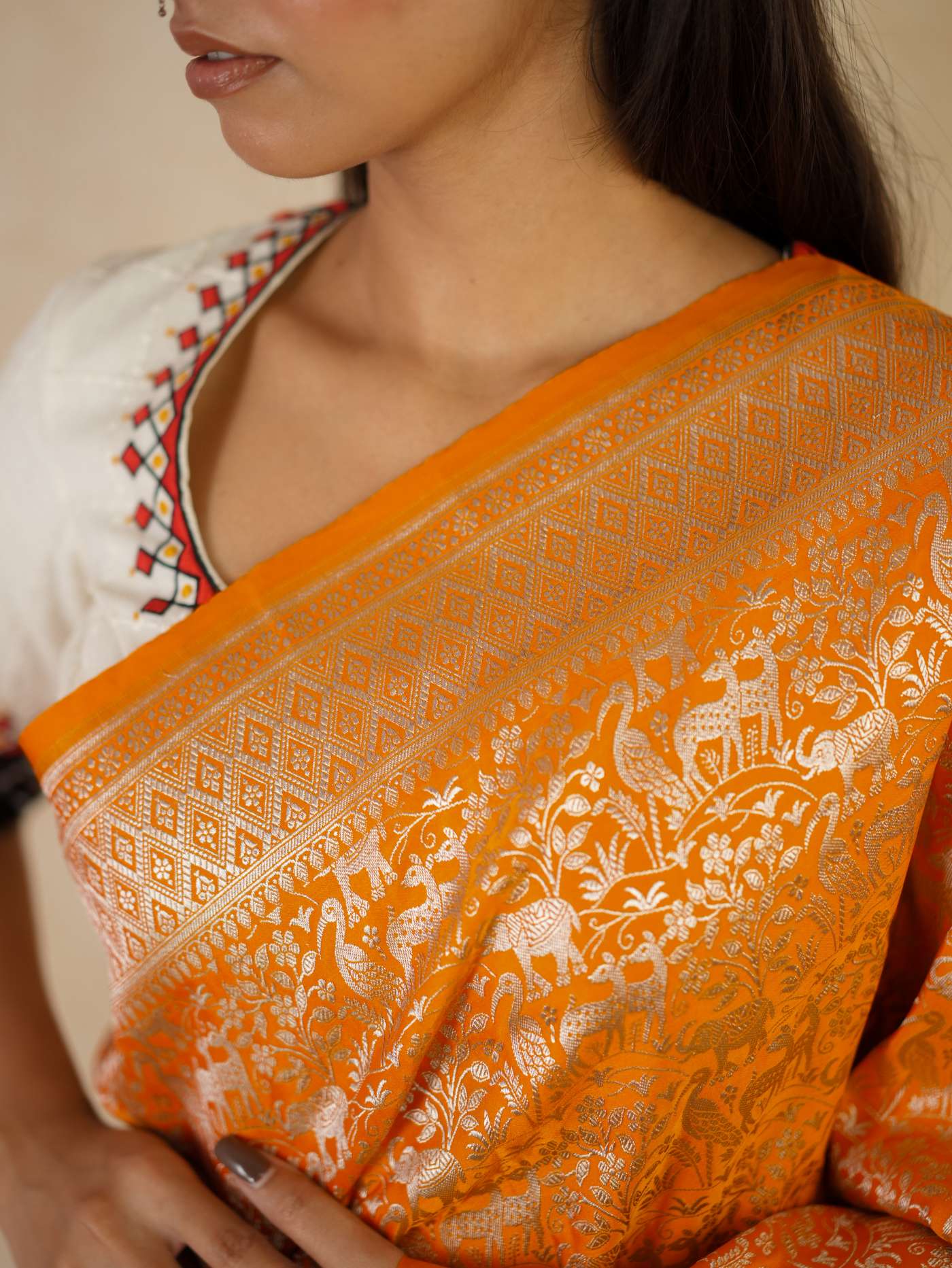 Orange semi-Benarasi silk saree with intricate patterns and matching blouse piece, traditional Indian attire from Joyee Kolkata.