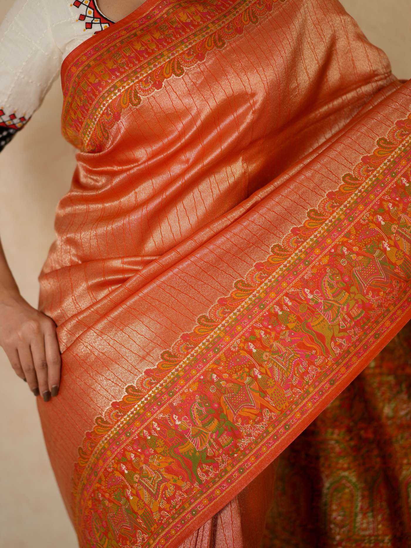 Reddish orange semi Benarasi silk saree with intricate patterns and matching blouse piece from Joyee Kolkata.