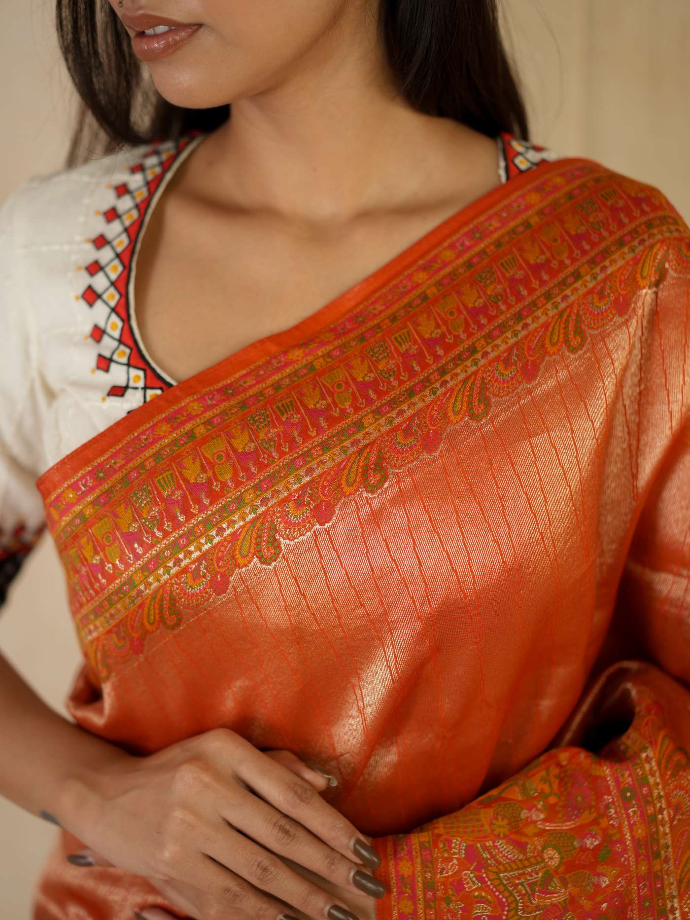 Reddish orange semi Benarasi silk saree with intricate designs and matching blouse piece, by Joyee Kolkata.
