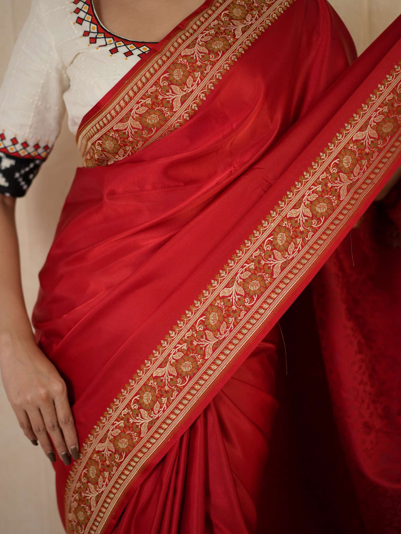 Rich red Benarasi semi silk saree with intricate gold motifs and matching blouse piece, elegant traditional Indian attire.