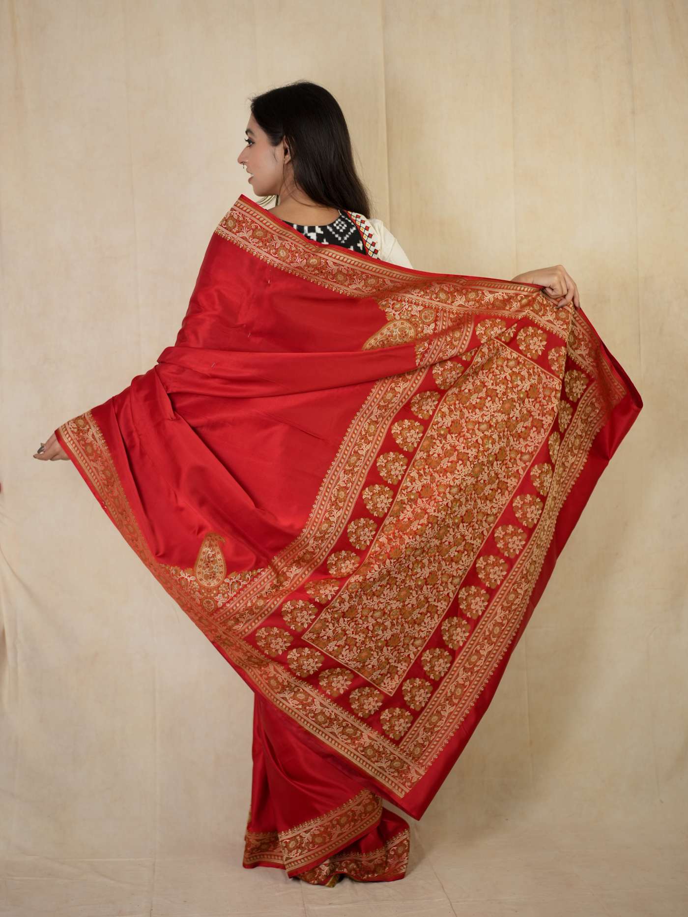 Rich red Benarasi semi silk saree with intricate gold details and matching blouse piece, from Joyee Kolkata.