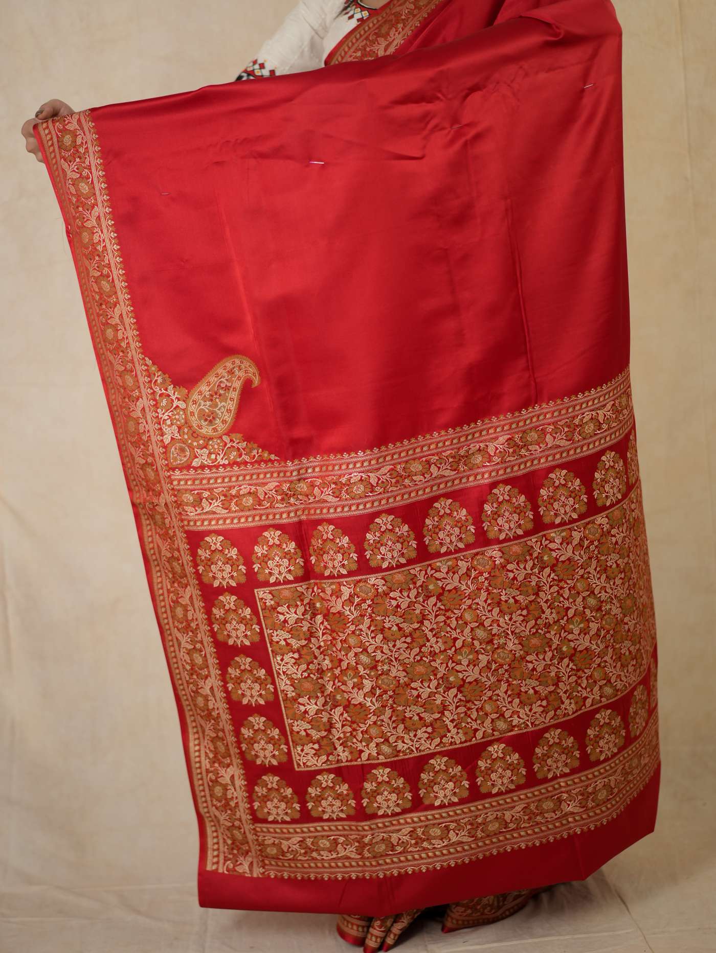 Rich red Benarasi semi silk saree with intricate gold motifs and matching blouse piece from Joyee Kolkata.
