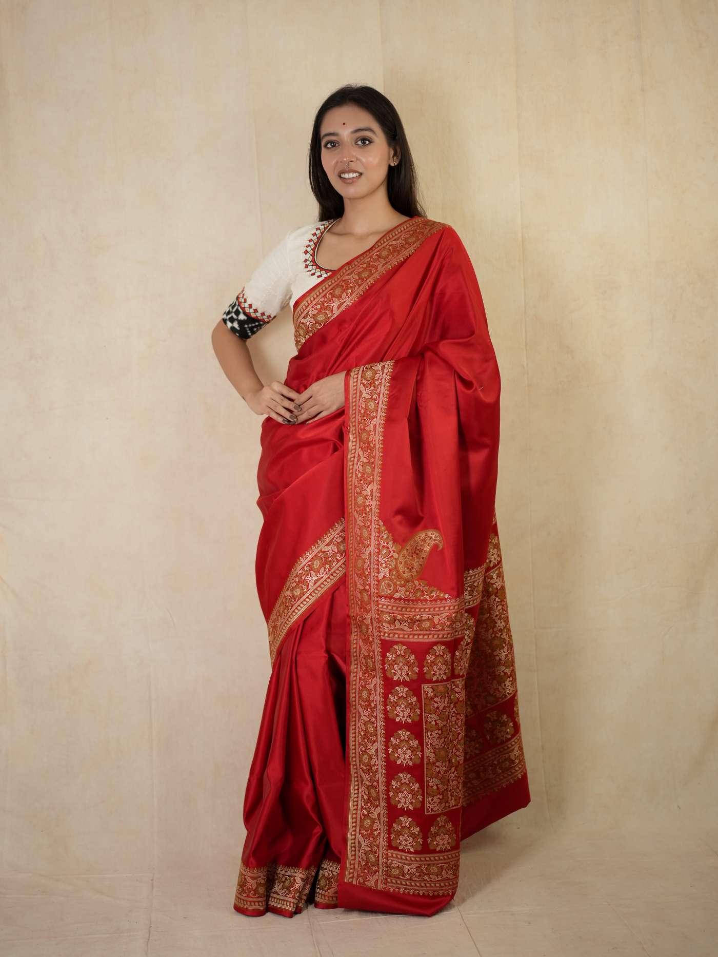 Rich red Benarasi semi-silk saree with intricate gold patterns and matching 1 meter blouse piece from Joyee Kolkata.