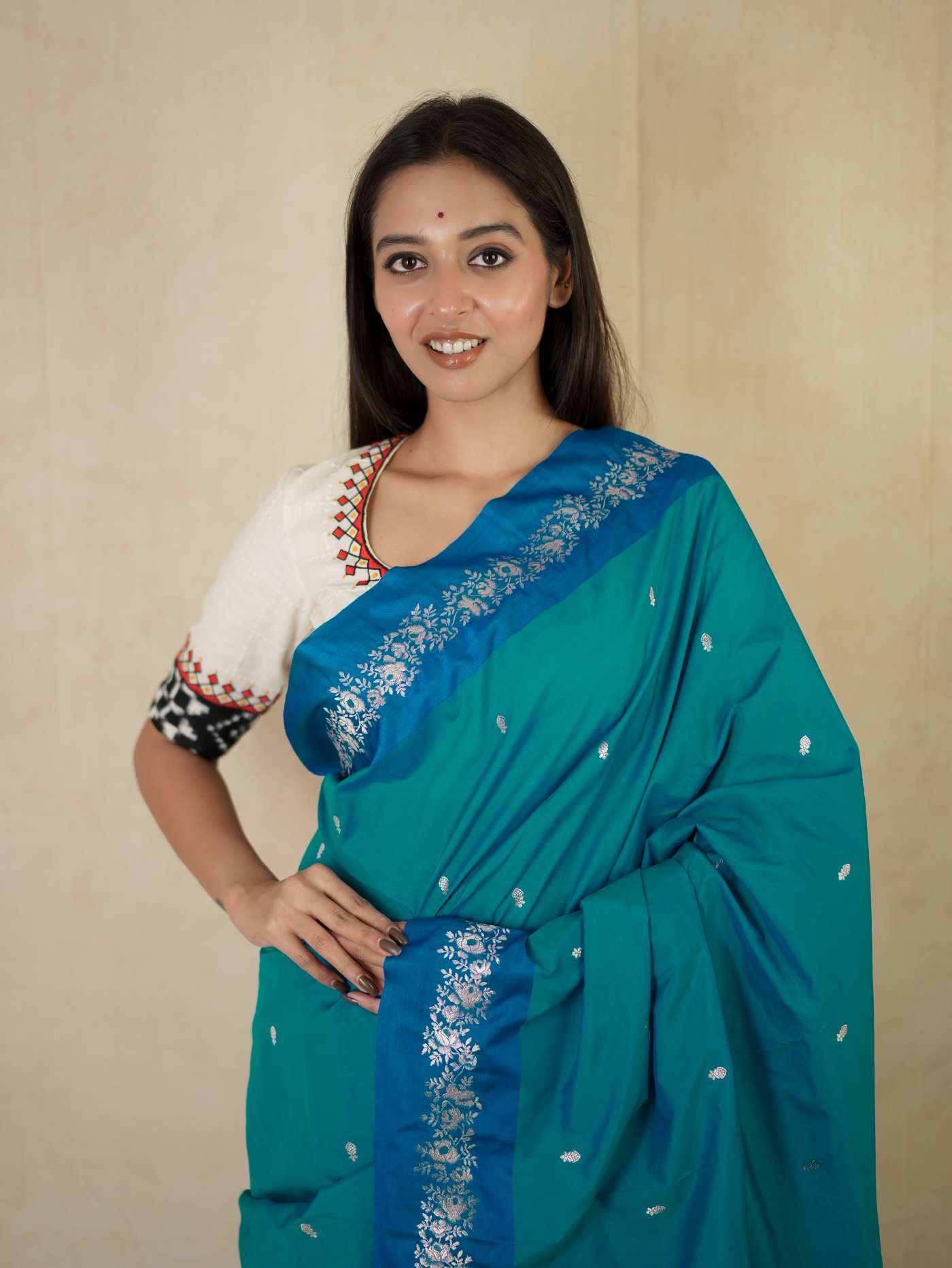 Turquoise blue semi-silk Benarasi saree with intricate designs and matching blouse piece, by Joyee Kolkata.