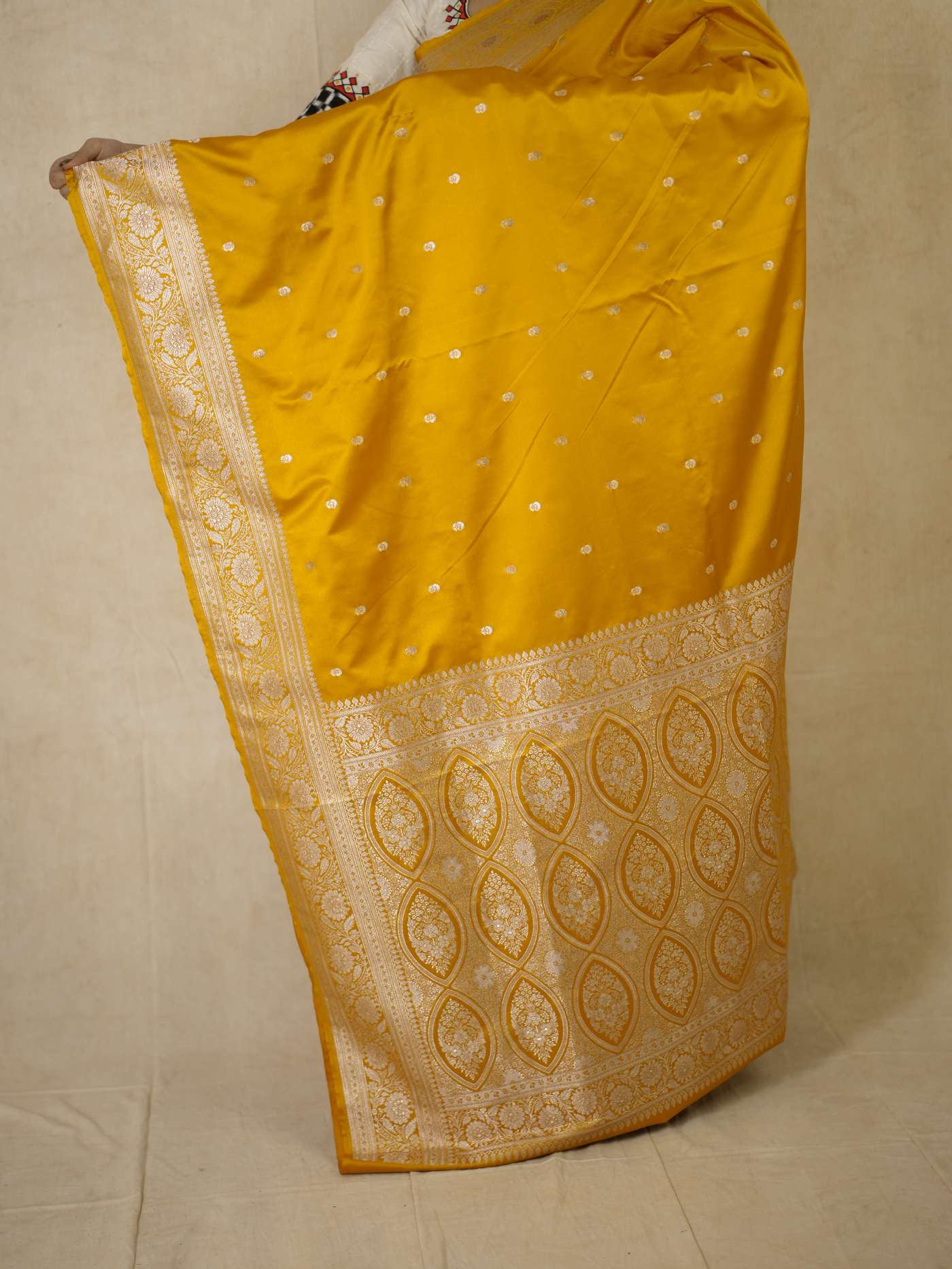 Yellow semi Benarasi silk saree with intricate patterns and a matching 1-meter blouse piece from Joyee Kolkata.
