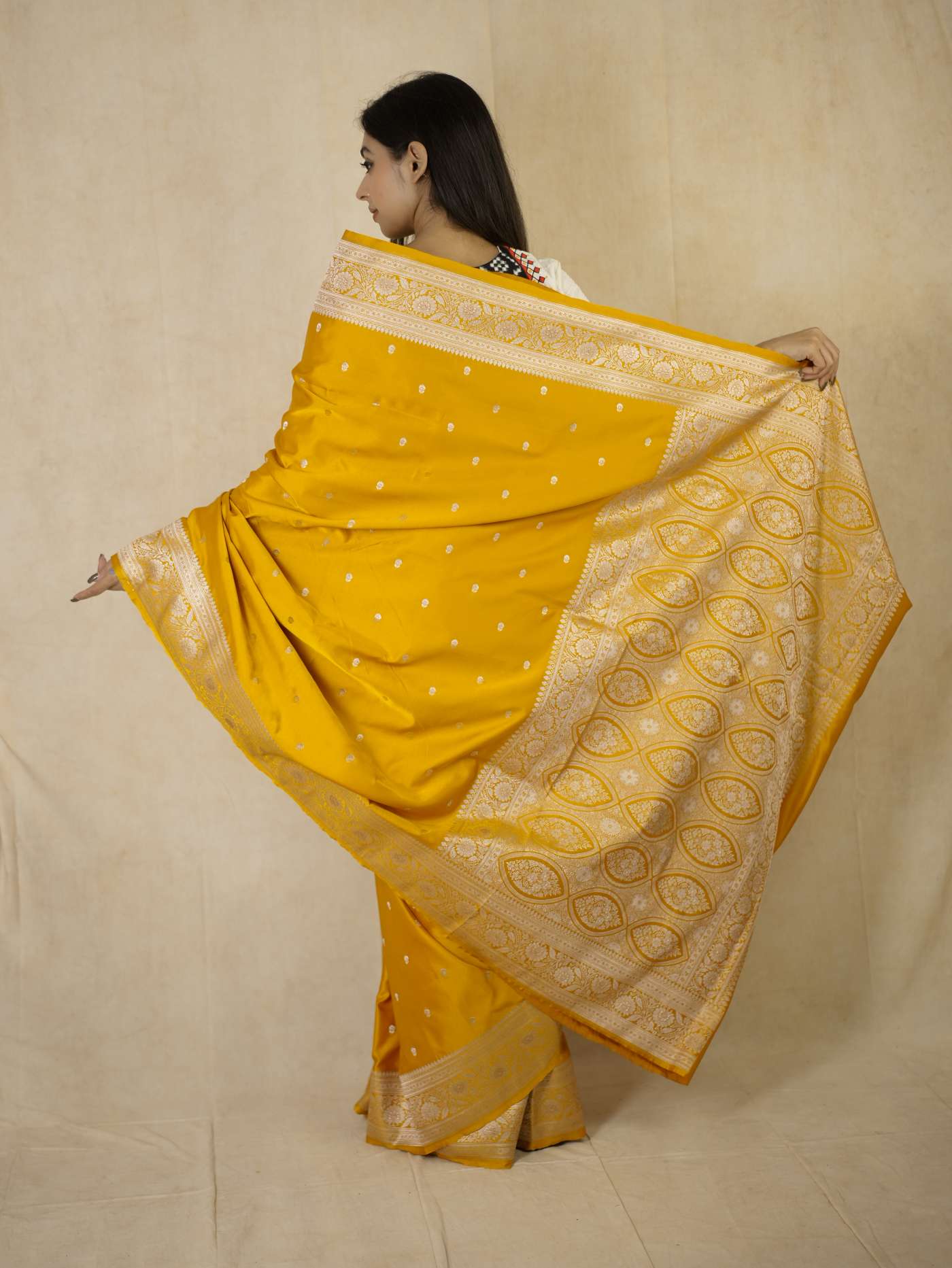 Yellow semi Benarasi silk saree with intricate designs and matching blouse piece from Joyee Kolkata, traditional Indian attire.